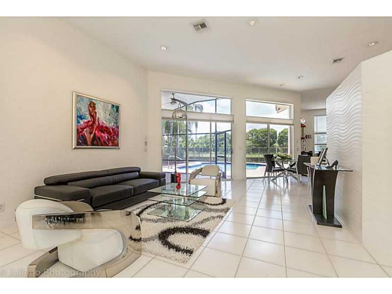 Stunning light and bright contemporary home with panoramic lake views and a large heated pool, located in beautiful Weston Hills Country Club community. It features a Tri-split floor plan with soaring ceilings and oversized windows that capture the pictur e perfect views.  Gorgeous sleek and modern finishes throughout, including brand new stainless steel appliances,  galaxy black granite countertop in the kitchen, LED recessed lighting and more.  A rated schools, country club membership optional.