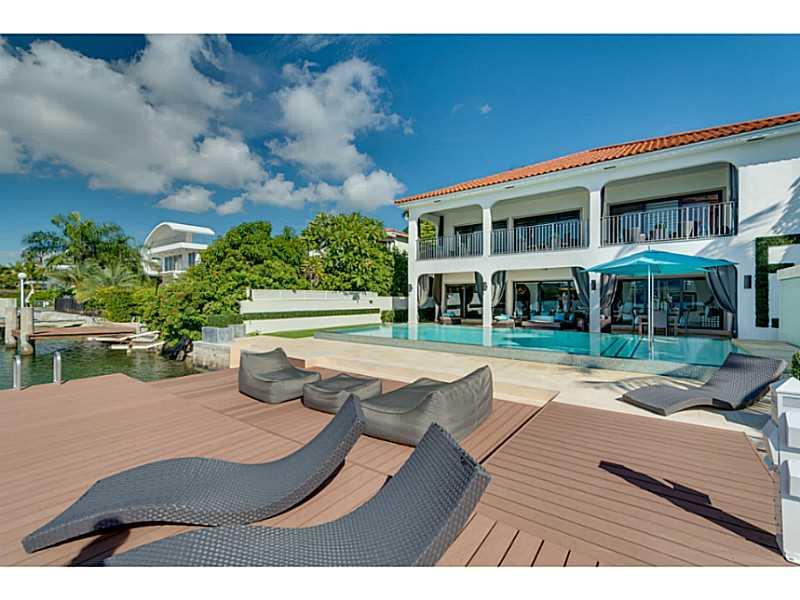 Spectacular Miami Skyline & open water views can be seen from this elegant Palm Island, 2-story residence w/heated Infinity pool, new large dock & 2-car garage. Interior features: LED lighting, elevator, custom shades, gourmet kitchen, wine cellar, wet bar, home theater, sound system & alarm system w/4 cameras. Formal dining rm, living rm, & family rm w/ceiling artwork. All large bedrooms w/en-suite baths & walk-in closets. Master w/Jacuzzi & terrace overlooking Downtown Skyline.
