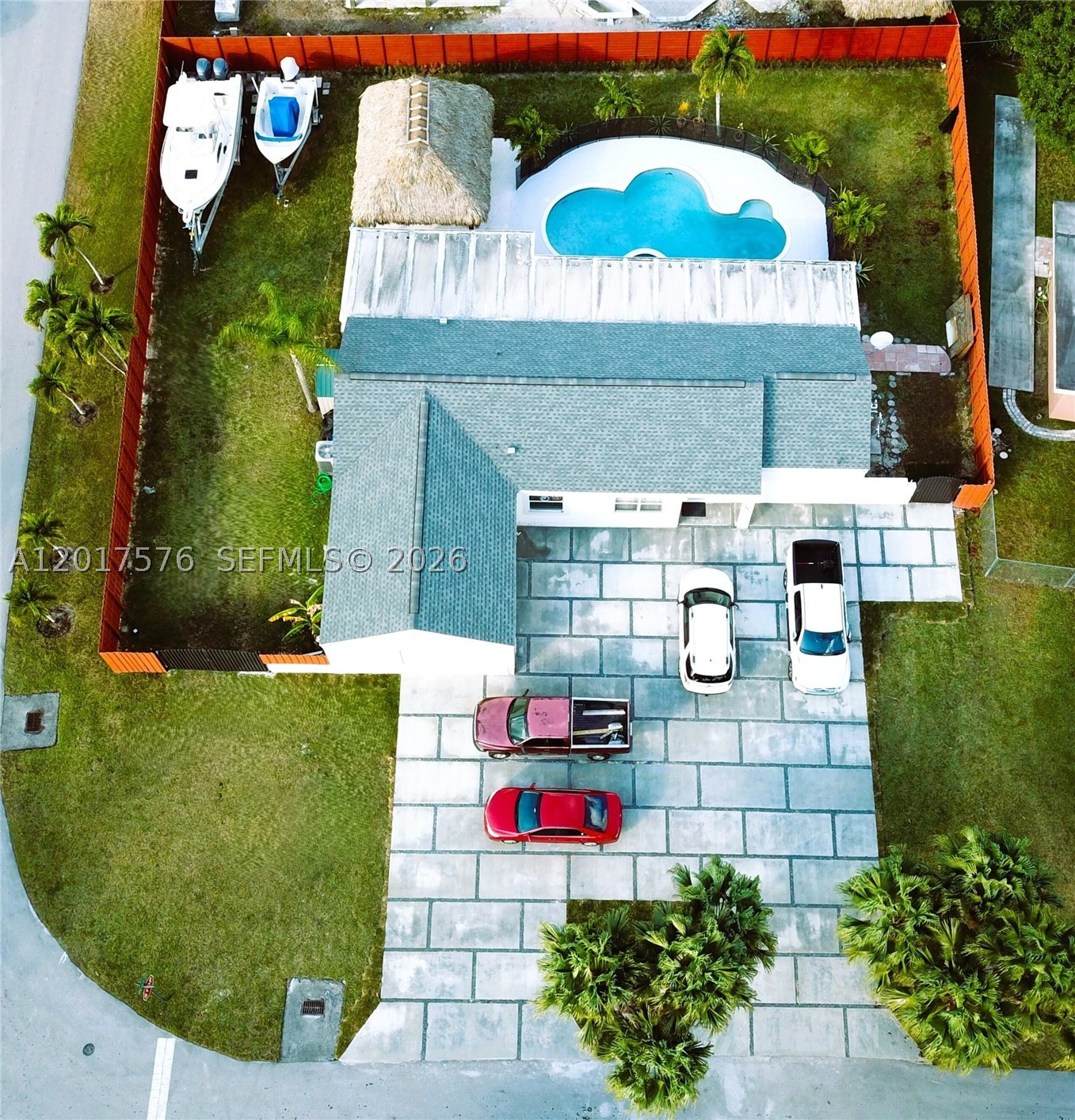 This beautiful home sits on an oversized 13K sq. ft. corner lot with a large, screened terrace, pool, privacy wood fence and tiki hut, excellent for entertaining with huge driveway for family and guests. Park an RV or boats along the extra wide side of this house and save on storage with plenty of space for all your toys plus a 2-car garage. Impact windows & doors, impact rated/insulated garage door, extra-large driveway, zebra shades, and ceramic floors. Quiet neighborhood with great neighbors. Grocery store + shops blocks away. Plenty of yard space for family and pets. Exterior freshly painted & pool replastered, new roof in 2017.