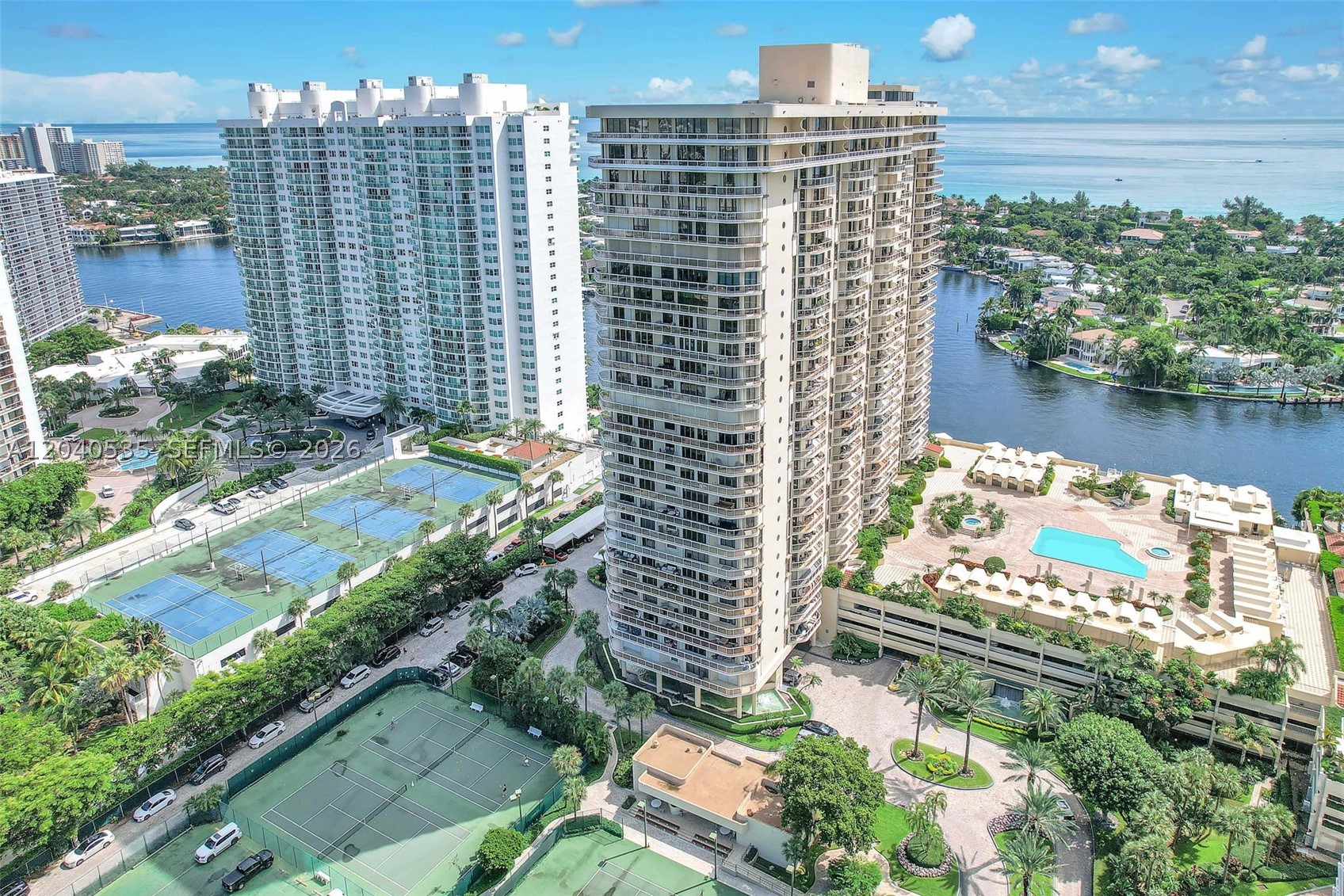 Enjoy breathtaking Intracoastal, ocean, Turnberry Golf Course, and Aventura skyline views from this spacious 2-bedroom, 2-bath residence offering 1,622 sq. ft. of living space in the prestigious Terraces at Turnberry. Filled with natural light, the home features marble flooring throughout the main living areas, an eat-in kitchen, washer and dryer, hurricane shutters, a large waterfront balcony, storage bin, and one covered parking space.

The seller has paid the special assessment in full, providing exceptional value and peace of mind for the new owner. Residents enjoy resort-style amenities including a heated waterfront pool, spa, sauna, two fitness centers, Pilates classes, tennis courts, pickleball, basketball court, clubhouse, library, community room, billiards room, pool café, towel service, scenic walking paths, and 24-hour security.

Ideally located in the heart of Aventura, just minutes from Sunny Isles Beach, Aventura Mall, Waterways Shoppes, Bal Harbour, fine dining, parks, cultural attractions, top-rated schools, and houses of worship. A fantastic opportunity to own in one of Aventura's most desirable waterfront communities.