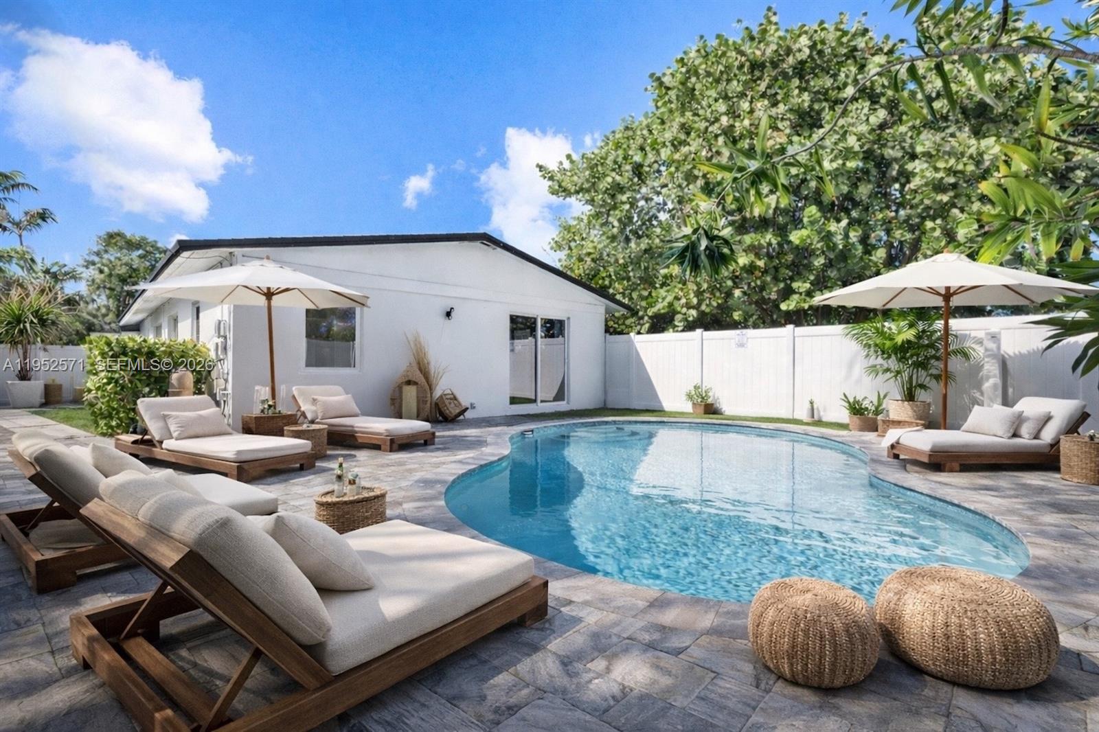 Welcome to this beautifully updated 3-bedroom, 2-bath residence offering 1,514 SF of living space on an oversized corner lot in Wilton Manors. Designed with an open and spacious layout, the home is filled with an abundance of natural light thanks to its desirable south-facing backyard and expansive sliding glass doors that seamlessly connect indoor and outdoor living. The renovated kitchen features a breakfast bar, electric cooktop, and stainless steel appliances, making it ideal for both everyday living and entertaining. The primary suite overlooks the pool and features sliding glass doors for effortless indoor/outdoor access, along with a primary bathroom featuring dual sinks and mirrored vanity. Additional highlights include impact doors and windows, updated plumbing, a 2022 roof, electric door locks, and a Ring camera system. A perfect blend of comfort, functionality, and modern updates in a prime location.