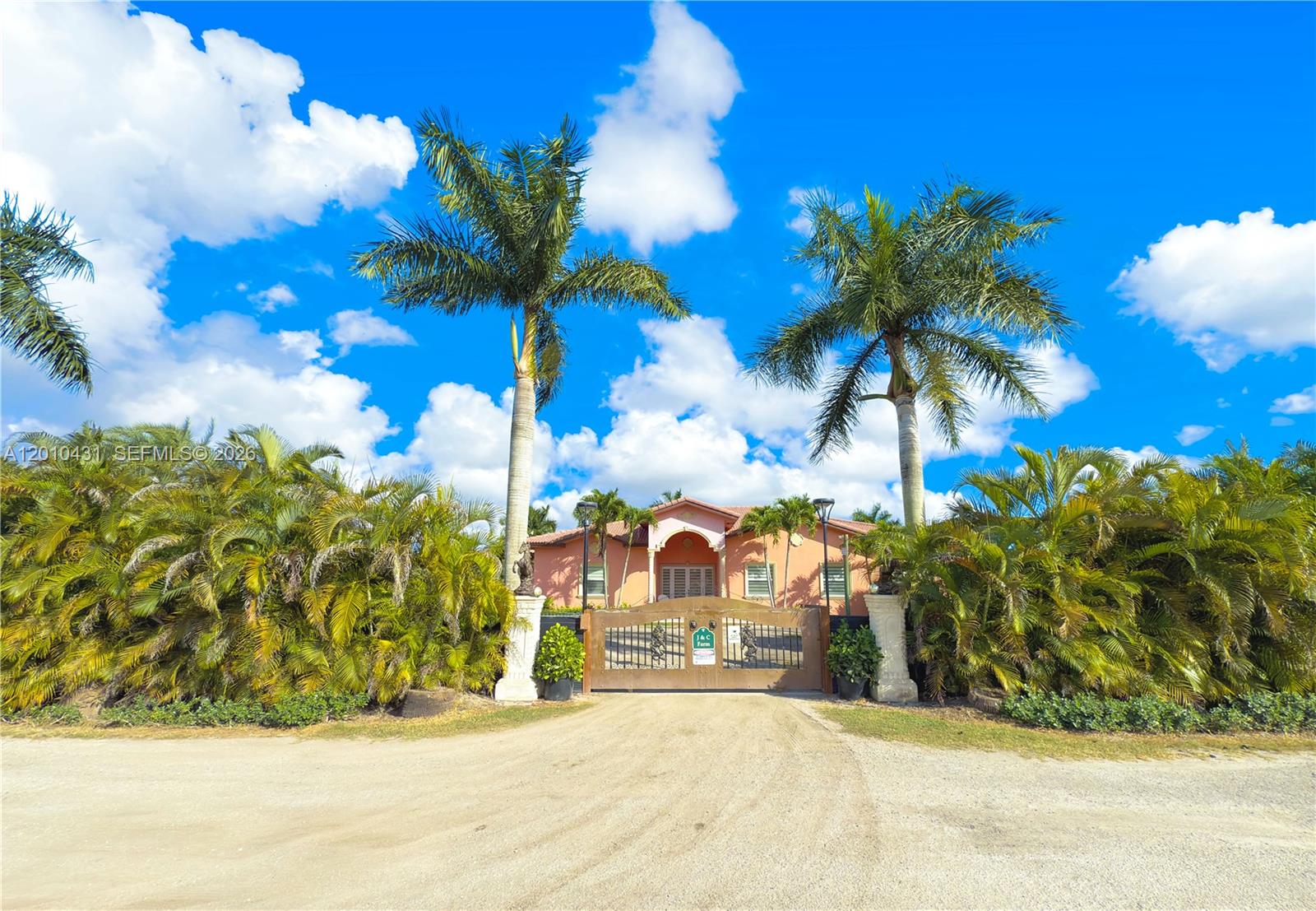 Welcome to the Redlands! Rare 5.2-acres income-producing estate where luxury living meets agricultural opportunity. Positioned on a corner lot, this gated property features three separate entrances for seamless access, operations, and privacy. The main residence, built in 2009, is a designer’s retreat offering 4 bedrooms, 3 baths, and a private 1/1 in-law suite with its private entrance. The second living unit is a detached Grandfathered 2-bedroom, 1-bath Guest House adding significant value, ideal for staff, guests, or rental income.
The property is fully equipped with a water purification system, a thriving nursery, and expansive open flex space ready for versatile farmland use. Enjoy a resort-style pond pool with cascading waterfalls, creating a true private retreat or event space.
Sale includes the complete, full operations as shown- setup with irrigation, two office spaces, and dedicated agricultural infrastructure, making this a turnkey opportunity for business or lifestyle use.
Prime location just minutes from Naranja and Quail Roost Dr. and under 10 minutes to the Florida Turnpike, this estate offers unmatched accessibility while maintaining total privacy. Ideal for a private compound, agritourism venture, or income-driven investment.