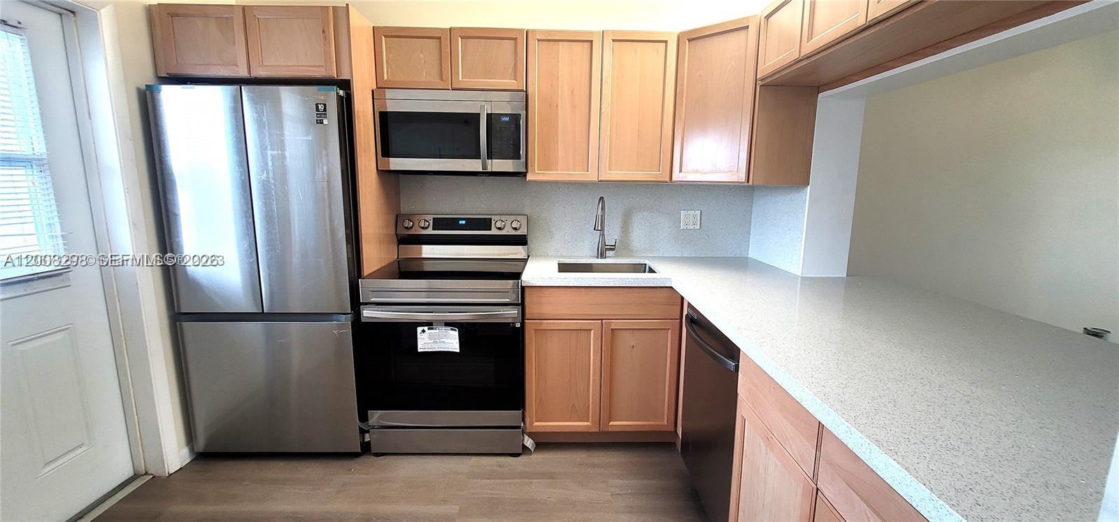 This beautifully updated 1 bedroom 1.5 bath condo is waiting for you! With screened porch in 55+ community. Renovated kitchen with quartz countertops and stainless-steel appliances, double door fridge. New A/C and compressor, new water heater, new vinyl floors, desk area with quarts top and updated bathrooms with new vanities and toilets. New faucets and lights, new fans and fresh neutral paint. New impact door. All done in 2023. Convenient location off of I95 near Hollywood close to shopping, restaurants and the beach. Ample closet space and unit comes with separate storage room. Many amenities include lakefront clubhouse, heated pool, gym and cable. Can rent after 1st year. Schedule your visit in advance. SELLER WILL PAY $23,000 SPECIAL ASSESTMENT WITH FULL PRICE OFFER