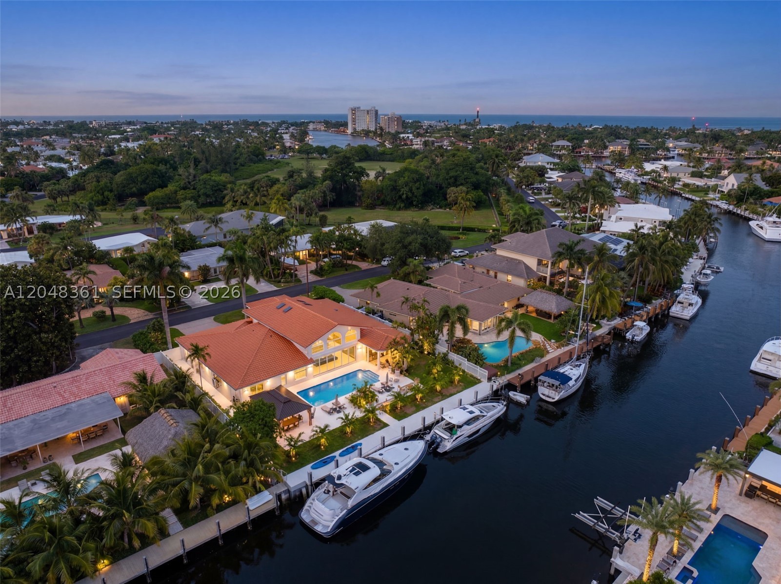Turnkey deep-water living in East Pompano Beach! Completely reimagined 4BR/5BA waterfront estate on an oversized 13,500 SF lot with 100 feet of BRAND-NEW seawall and dockage on a wide canal - no fixed bridges and minutes to the Intracoastal and Hillsboro Inlet. Nearly everything is new: roof, impact-rated windows, flooring, A/C systems, designer bathrooms, and a state-of-the-art chef's kitchen with gas range, dual waterfall-edge islands, and custom cabinetry. Soaring 15-foot ceilings, skylights, and walls of glass fill the great room with light and frame views of the resurfaced, heated pool. The expansive backyard offers lush new landscaping, generous green space, and two gazebos - one with a full summer kitchen, built-in grill, and beverage center. A circular paver driveway welcomes you home, and the 2-car garage features two dedicated A/C zones (parking bay + workshop) plus electric car chargers. Approx. 3,500+ SF of bright, open living space. Dock your yacht out back and move right in - this one checks every box!