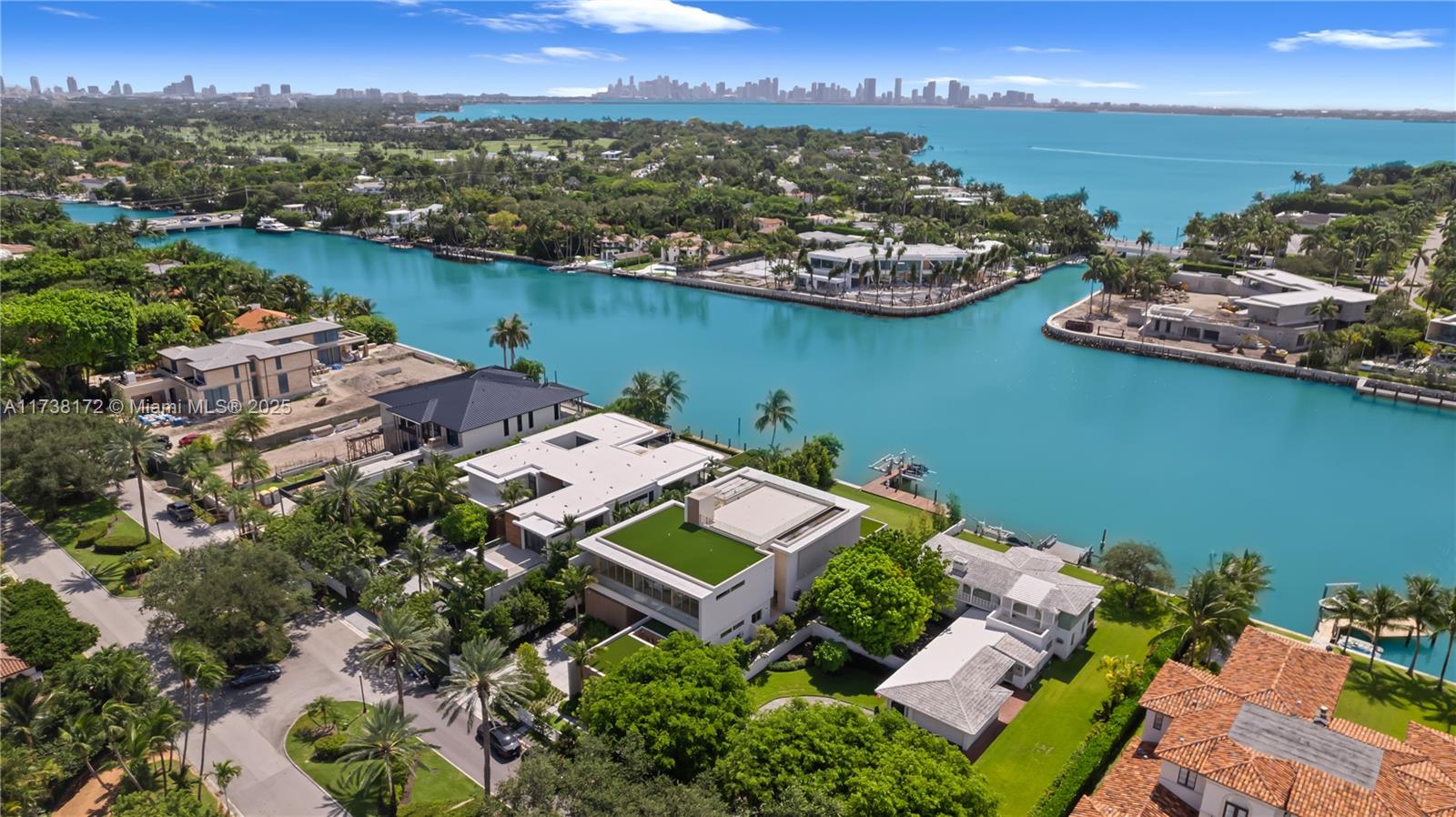 Discover unparalleled luxury at 6494 Allison Road, a waterfront masterpiece on gated Allison Island. This newly completed estate boasts 6 bedrooms, 8.5 bathrooms, and 8,024 sqft of refined living space. The primary suite is a private retreat with a sitting area, dual spa-inspired baths, and spacious closets. A MiaCucina kitchen, equipped with premium Wolf and Subzero appliances, is designed for culinary excellence. Control4 automation seamlessly enhances modern living. Additional features include a 2-car garage with lifts, a rooftop terrace, and a gym with sauna and steam rooms. Outdoors, enjoy an infinity-edge pool, summer kitchen, and a 40,000 lb boat lift with two waverunner lifts. A perfect blend of sophistication and craftsmanship.