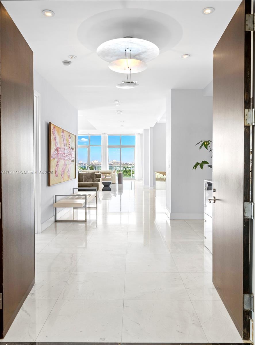 Undeniably the best residence at Aqua, the 1001 is a stunning, sun-lit lower penthouse where modern luxury meets breathtaking views. 3,321 SF of elegant living space plus 420 SF of wrap-around terraces. This 3-bedroom and 3.5-bathroom residence boasts soaring 14-foot ceilings, expansive walls of glass, and an open, airy ambiance that invites natural light to fill every corner. Enjoy sweeping views of the iconic Miami skyline, ocean, and Intracoastal from every room. Featuring bright and extremely spacious living areas, marble floors, and sophisticated furnishings. Three parking spots. Two large dogs are allowed.
Aqua Allison Island is an exclusive 8.5-acre private island community with world-class amenities set amidst lush gardens. In the heart of Miami Beach, steps away from the beach.