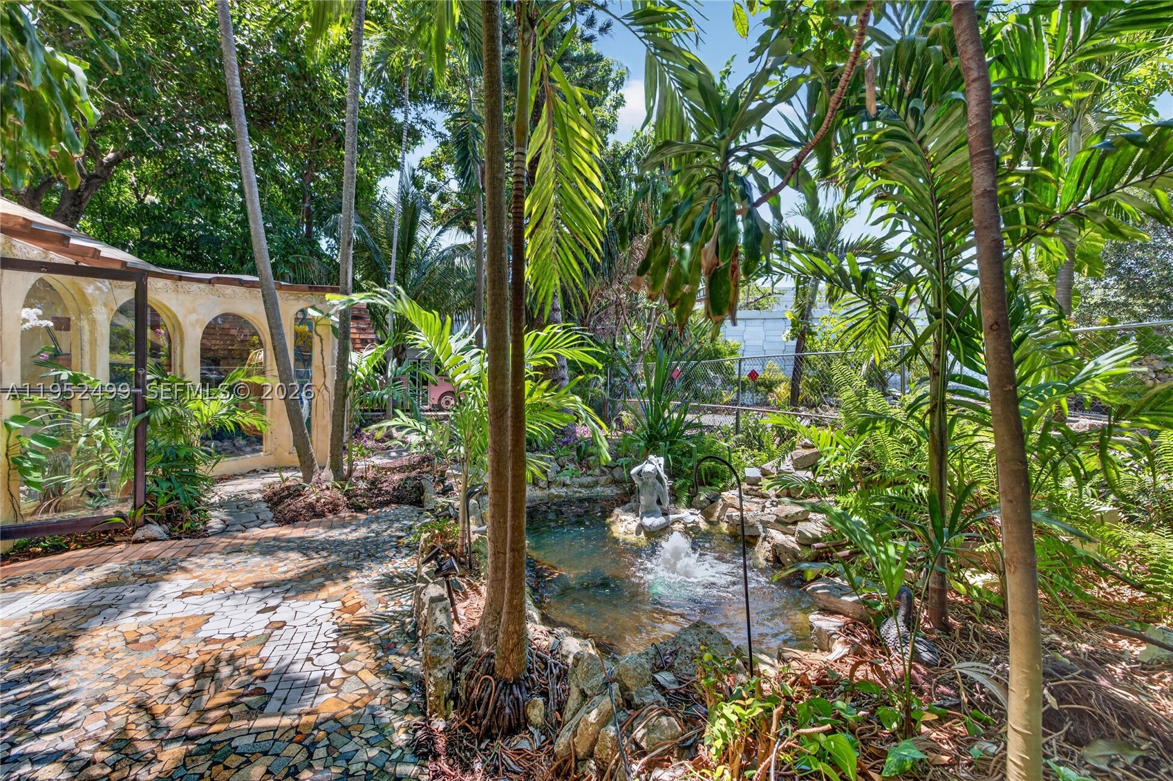 Stroll into a serene botanical garden. Bubbling koi pond fountains & waterfalls invite you to relax & unwind in a tropical fruit tree paradise. An orchid atrium welcomes you at the front door. Granite floors, custom finishes, walk-in closets & updated bathrooms, plumbing, AC, & electrical give a solid, polished, upscale feel to this unique home. River rock fireplaces, picture windows, & open beam ceilings provide an extraordinary warm & magical ambiance. This is not your typical cookie cutter house. 5-10 minutes from Wilton Manors, Ft. Lauderdale, airports, & great shopping & dining. A large deck & gazebo, oversized third acre lot, tiki hut, river rock pizza oven/grill, & privacy fencing make this the perfect place for entertaining or wandering through your own private Zen retreat.