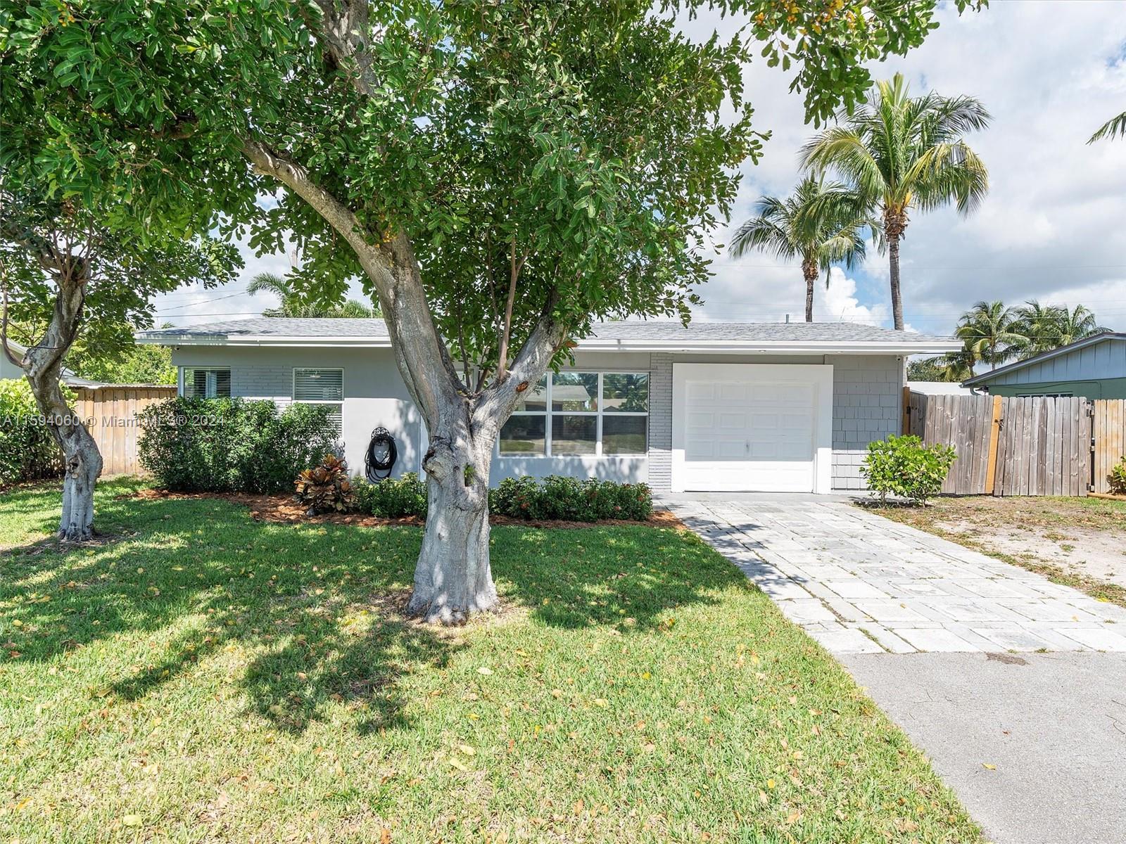 Charming single family with 2 bedrooms and 1 bathroom and no HOA! The heart of this home is the beautifully updated open kitchen, with stainless steel appliances, and quartz countertops. Bonus room could be used as an office, formal dining room, family room or additional bedroom. Renovated bathroom. Tile flooring on the common areas and carpet on the bedrooms. Fully fenced, large backyard with plenty space for a pool. 1-car garage. BRAND NEW ROOF. A/C 2020. Impact windows and door. Convenient location with easy access to all beaches, restaurants, golf course, dog park, shopping, tri-rail, Brightline Express train, Turnpike, and I-95!