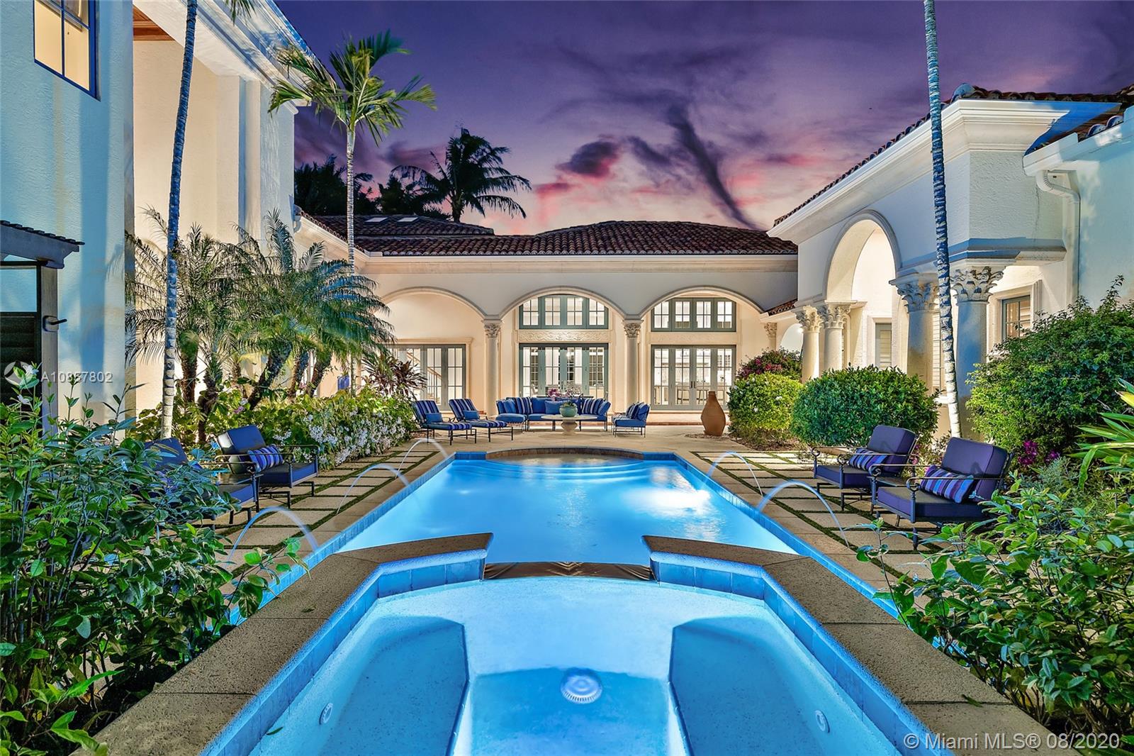 Timeless Beauty. This home boasts 5 bdrms/5.3 baths & 3.5 car garage. The moment you enter though the iron gates you're welcomed by lush tropical landscaping and a pool/patio area that feels like a resort. The chef's kitchen features gas range, white waterfall counters, butler's pantry, bar seating all opened to the family room. Luxurious master suites has large boutique style closets, marble bath, dual water closets, Roman style bath surrounded by a privacy garden and over sized shower. 4 guest rooms with private baths. 2 guest rooms are connected to a second floor living area, 2 guest suites are in the 2 story guest house, connected to the main house. Detailed flooring and moldings, entertaining wet bar that overlooks the elegant living room. Protected dock, 2 lifts, water & electric.