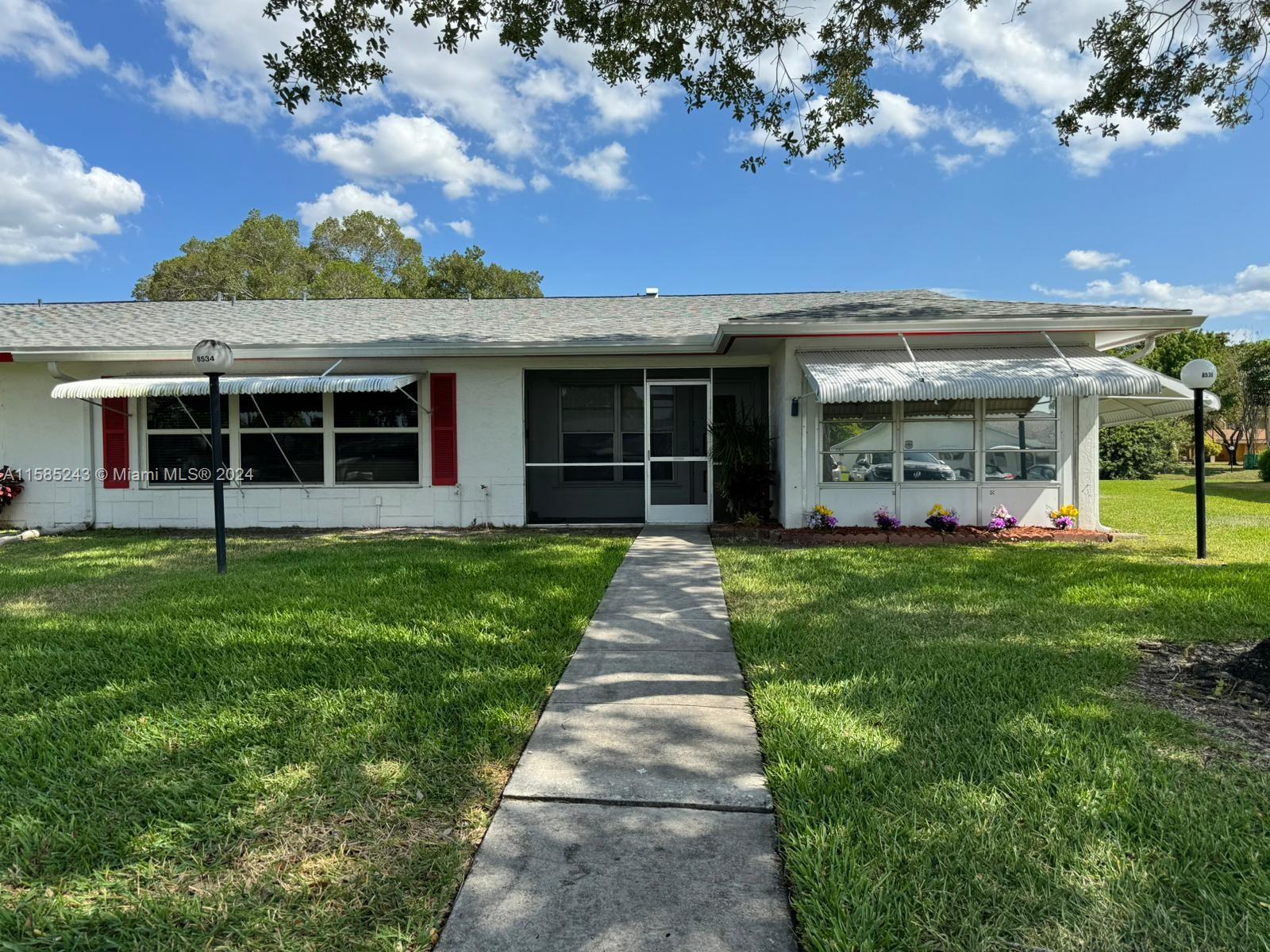 Spacious WATERFRONT villa in LAUDERDALE WEST with a enclosed bonus room. This immaculate home has been completely painted and ready for you to move right in. All tile floors, washer and dryer, closet built ins. Updated kitchen with up lighting. This highly desirable over 55 community has everything. Two heated pools/spas tennis courts, shuffleboard, billiards, gym, card room, activity rooms. A huge theater with professional shows. Lots of activities and occasions to socialize. Maintenance takes care of the lawn, internet/cable, exterior painting, courtesy bus to shopping and much much more.  Located in the heart of Plantation close to everything.