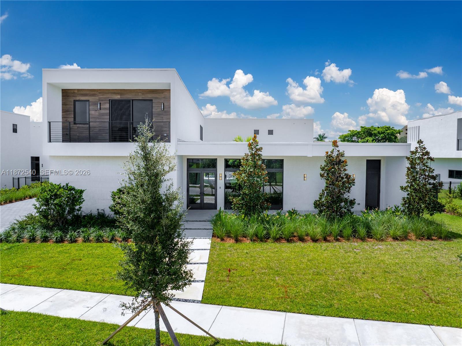 Discover elevated modern living in this redesigned O3A Model Residence at Botaniko Weston. Nestled on over half an acre, this architectural showpiece offers 6,000+ sq. ft. of sleek, sophisticated design. The home blends clean lines with bold character. Every detail has been purposefully curated from the chef’s kitchen with an oversized quartz island and premium appliances to the seamless indoor-outdoor flow. The layout includes five ensuite bedrooms, six and a half bathrooms, a private media room, executive office, maid’s quarters, and a generous three-car garage. Outdoors, the resort-style pool and spa are framed by lush, manicured landscaping, creating a serene, private escape ideal for relaxing or entertaining.
