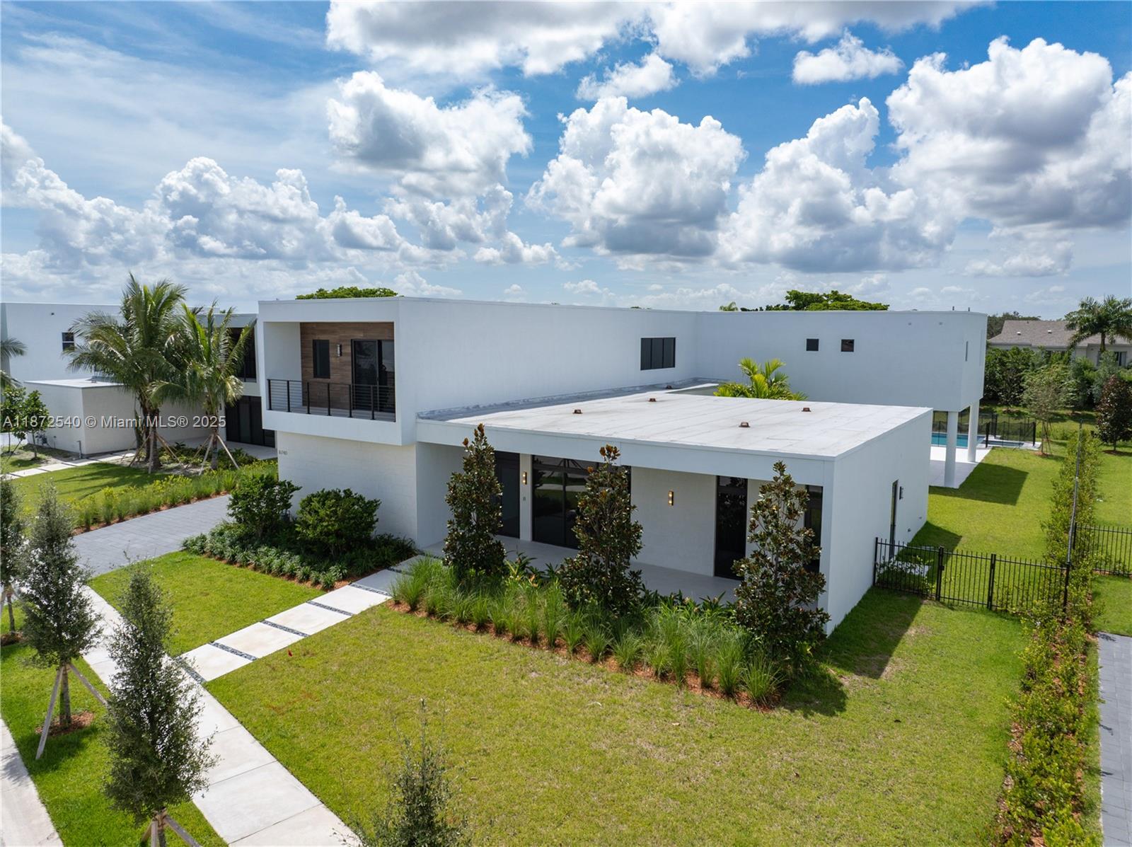 Discover elevated modern living in this redesigned O3A Model Residence at Botaniko Weston. Nestled on over half an acre, this architectural showpiece offers 6,000+ sq. ft. of sleek, sophisticated design. The home blends clean lines with bold character. Every detail has been purposefully curated from the chef’s kitchen with an oversized quartz island and premium appliances to the seamless indoor-outdoor flow. The layout includes five ensuite bedrooms, six and a half bathrooms, a private media room, executive office, maid’s quarters, and a generous three-car garage. Outdoors, the resort-style pool and spa are framed by lush, manicured landscaping, creating a serene, private escape ideal for relaxing or entertaining.