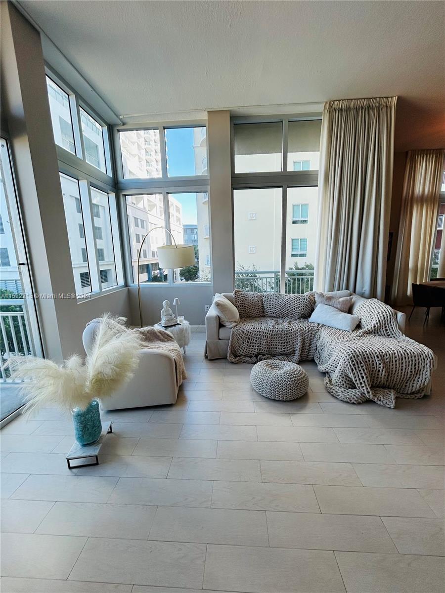 Stunning large 1 bed/1bath corner loft w/ 13'ceilings & expansive view, in prestigious Metropolis Tower at Dadeland. Publix next door and one block from the Metrorail. Airy, bright & cheerful, this unit boasts off- white porcelain tile flooring laid to look like wood. Enclosed bedroom with French door, California closet, granite counter tops with S.S. appliances & large den/dining area. Unit has custom made neutral color drapes from floor to ceiling, neutral colors throughout. NEW washer & dryer combo, 2 balconies. Basic cable/internet included. 1 assigned parking space.
