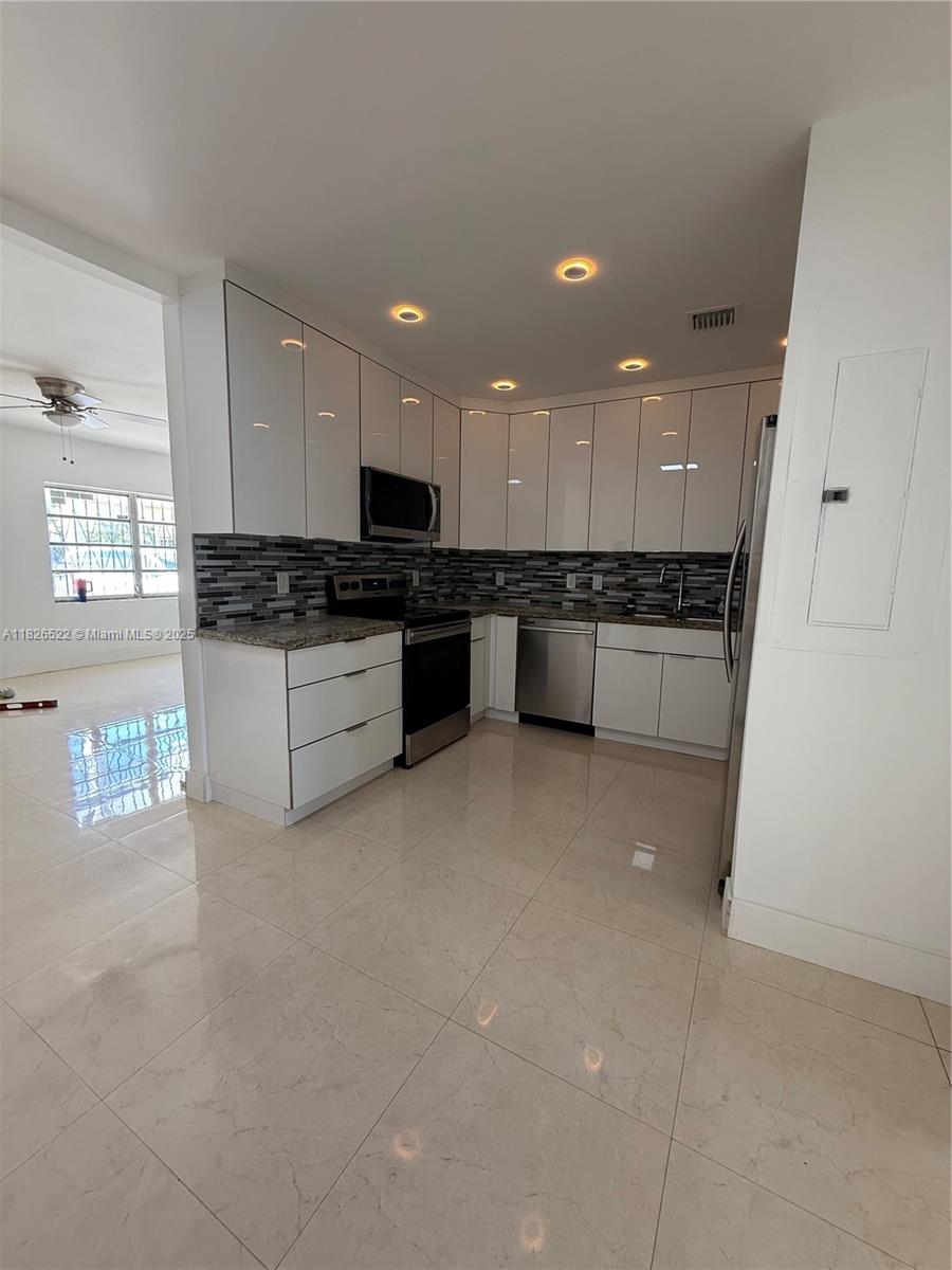 Step into modern comfort with this fully renovated 3-bedroom, 2.5-bathroom home, perfectly designed for both style and functionality. Enjoy the peace of mind and energy efficiency that comes with brand-new impact windows and doors. The interior has been thoughtfully upgraded, featuring a brand-new kitchen with contemporary cabinetry, sleek countertops, and stainless steel appliances—ideal for cooking and entertaining. All bathrooms have been completely remodeled with modern finishes, offering a spa-like feel. With spacious bedrooms, ample natural light, and a seamless layout, this home combines practicality with refined design. A perfect choice for those seeking quality, comfort, and peace of mind.