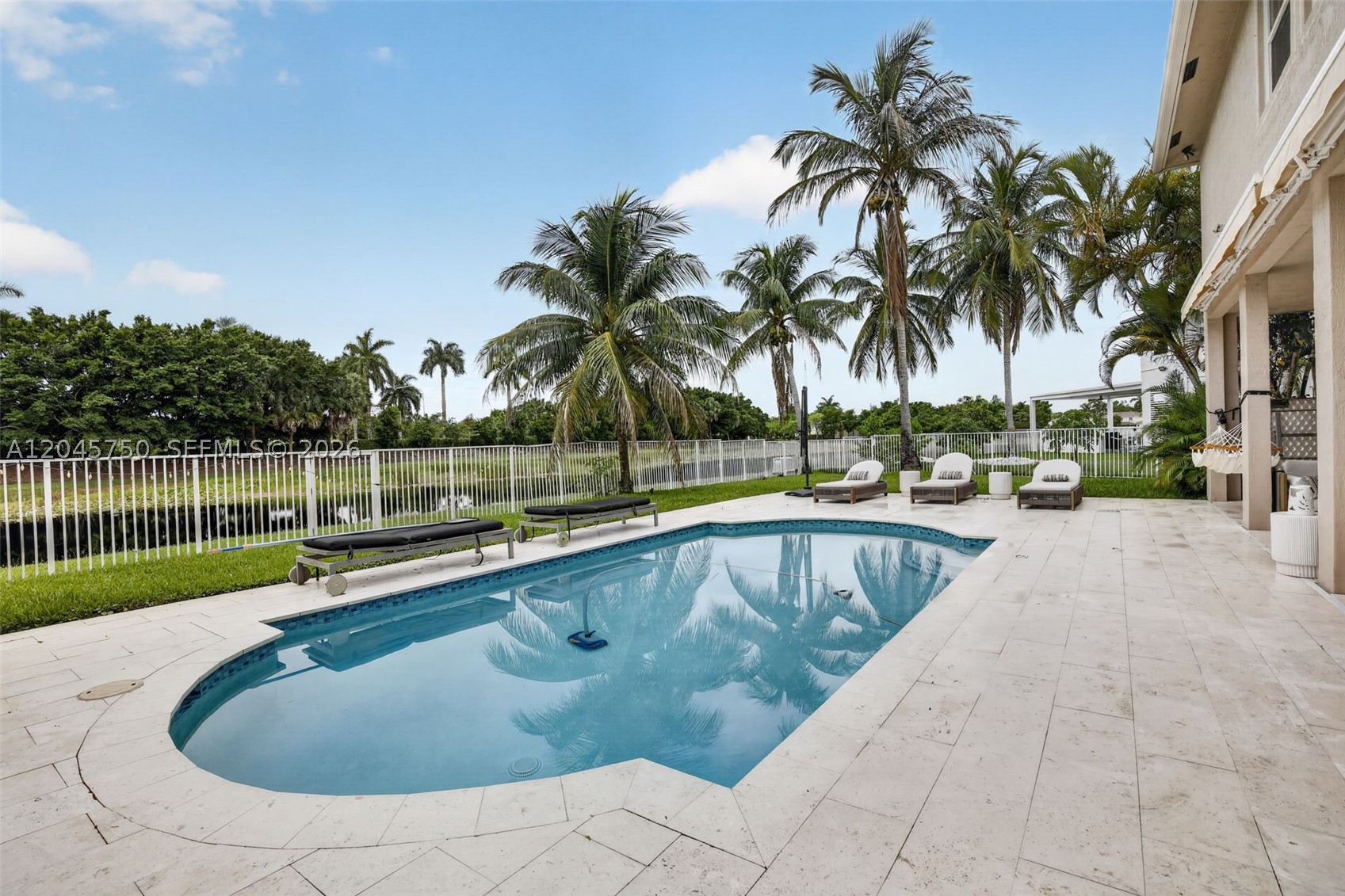 Welcome to Savanna, one of Weston's most sought-after gated communities. 
Nestled at the end of a quiet cul-de-sac on a generous pie-shaped lot with direct frontage to the community's lake, this beautifully maintained 6-bedroom, 6-bathroom two-story home offers over 4,000 sq ft of living space and an open, flowing floor plan filled with natural light. The spacious kitchen features a cooking island, pantry, and breakfast area that opens seamlessly to the living and dining rooms — perfect for entertaining. The primary suite upstairs offers a luxurious retreat with separate tub and shower, while the first-floor bedroom suite is ideal for guests or in-law quarters. A dedicated guest bathroom doubles as a cabana bath, providing effortless access to the pool area and deck. Step outside to your covered summer kitchen and expansive deck — an entertainer's paradise. The home is fully equipped with high-impact windows and doors throughout for complete storm protection and peace of mind. A brand new roof will be completed by closing. Additional highlights include a 3-car attached garage with EV charging station, laminate and tile floors, walk-in closets, closet cabinetry, and a fenced backyard. Savanna's resort-style amenities include a magnificent clubhouse, heated lap pool, kids' pool, soccer field, basketball court, playground, and 24-hour security patrol. Zoned for A-rated Gator Run Elementary, Falcon Cove Middle, and Cypress Bay High School. This is Weston living at its very best!