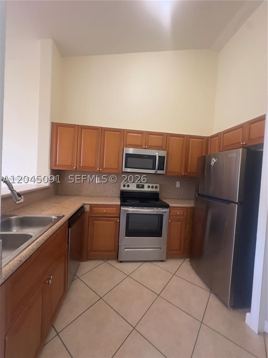 Bright and beautifully maintained **first-floor corner unit** featuring **3 bedrooms and 2 full bathrooms** in the desirable **Shoma Homes at Keys Cove** community. Freshly painted and filled with natural light, this spacious condo offers tile flooring throughout, an open-concept kitchen, ample closet space, and an in-unit washer and dryer for added convenience. The split-bedroom layout provides comfort and privacy, making it ideal for families or professionals. Conveniently located near shopping centers, restaurants, schools, Baptist Hospital Homestead, Homestead Air Reserve Base, Florida's Turnpike, and US-1, offering easy access to everything you need. Association approval required.
