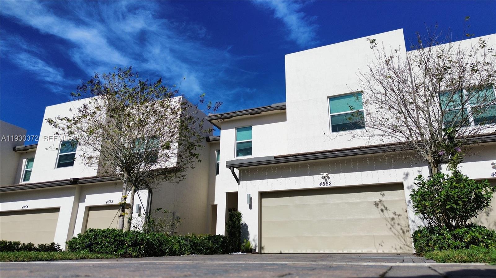 Step into this beautiful, like-new townhome built in 2021, located in the charming Andalucia community in the sought-after Wellington / West Lake Worth area. This thoughtfully designed 3-bedroom, 2.5-bath home offers a contemporary kitchen with grey cabinetry, quartz countertops, an oversized island, and a spacious pantry, perfect for everyday living and entertaining. The home features a renovated entryway with an elegant designer accent wall, LED lighting throughout, and a security system with sensors and a camera.

Additional highlights include a spacious 2-car garage, impact-resistant windows and doors, and tranquil lakefront views. Andalucia is located within an A-rated school district and provides convenient access to the Florida Turnpike, SR-7/441