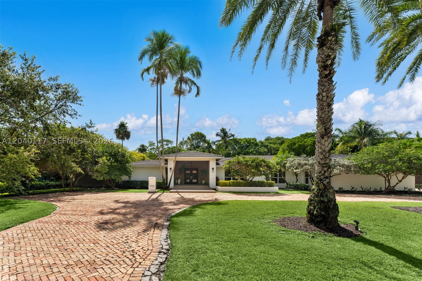Situated on a 26,536 SF corner lot in the desirable Pine Bay Estates community, this well-appointed residence offers 5 bedrooms, 3 bathrooms, and a private home office. Floor-to-ceiling windows fill the home with natural light, enhancing the formal living and dining rooms and creating an inviting atmosphere throughout. Custom built-in cabinetry, spacious living areas, and thoughtful design provide both comfort and functionality. The primary suite serves as a private retreat, featuring his-and-hers walk-in closets and a spacious bath with a freestanding soaking tub and separate shower. Designed for seamless indoor and outdoor living, the home opens to a covered terrace overlooking the pool and summer kitchen, creating the perfect setting for entertaining and everyday enjoyment. Additional highlights include a 2-car garage, mature landscaping, and a prime Pinecrest location near top-rated schools, parks, and dining