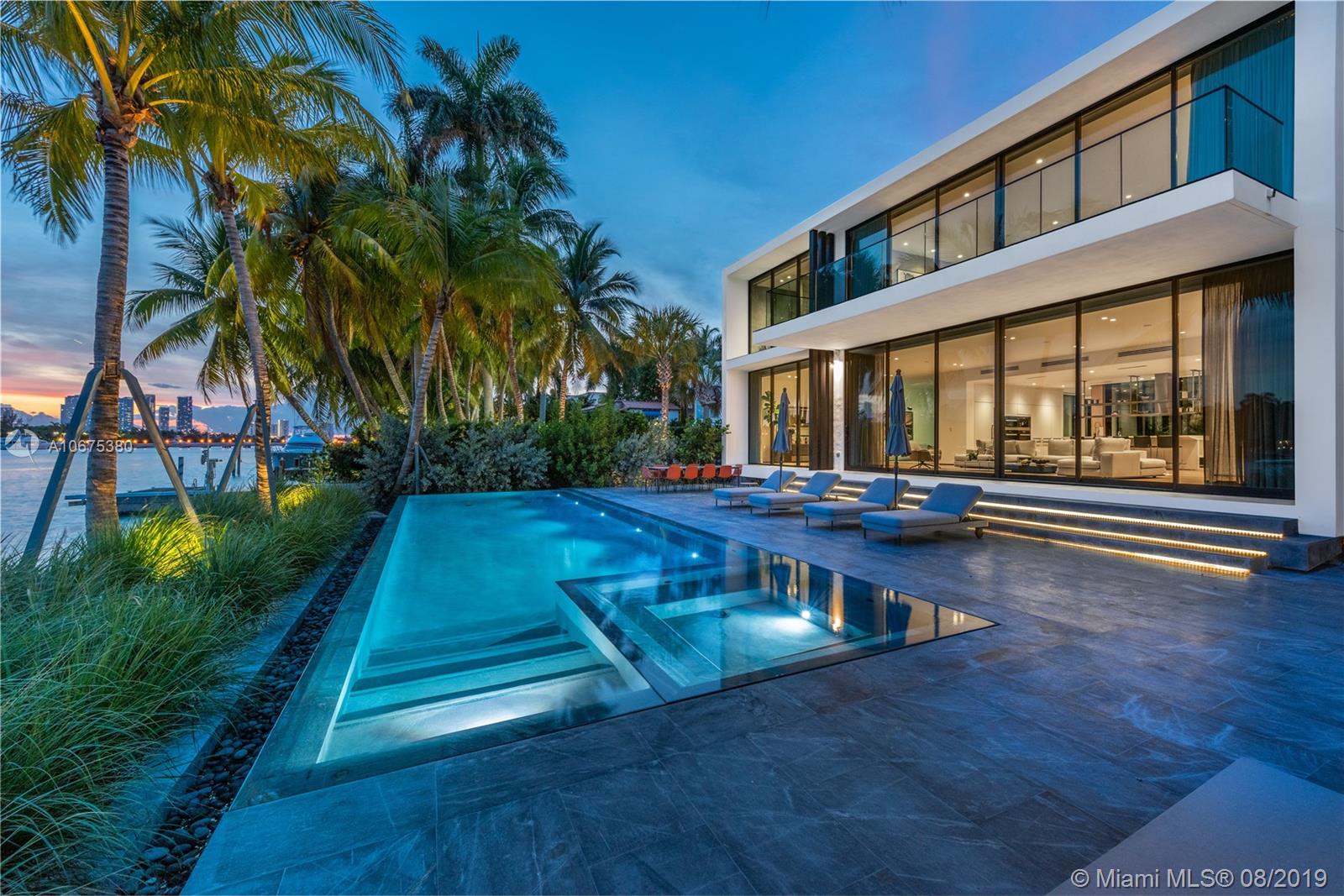 New Modern, Uniquely designed Elevated “Glass” house on gated and secured Hibiscus Island. Southern exposure, panoramic views of Biscayne Bay and Downtown. Private entry garden capturing sea breeze with an open floor plan with tall 20’ ceiling entry leading to glassed central courtyard, adding natural light and enhancing views. Spacious master suite, captivating scenes and oversized terrace. Rare separate guest house with full kitchen and 2 car garage. Custom furniture professionally decorated throughout. Sleek infinity edge pool with concealed equipment, outdoor kitchen and custom outdoor seating. Elevator leading to private rooftop terrace. Island amenities include tennis, basketball, playground, newly paved streets, new utilities, new landscaping and police protection.