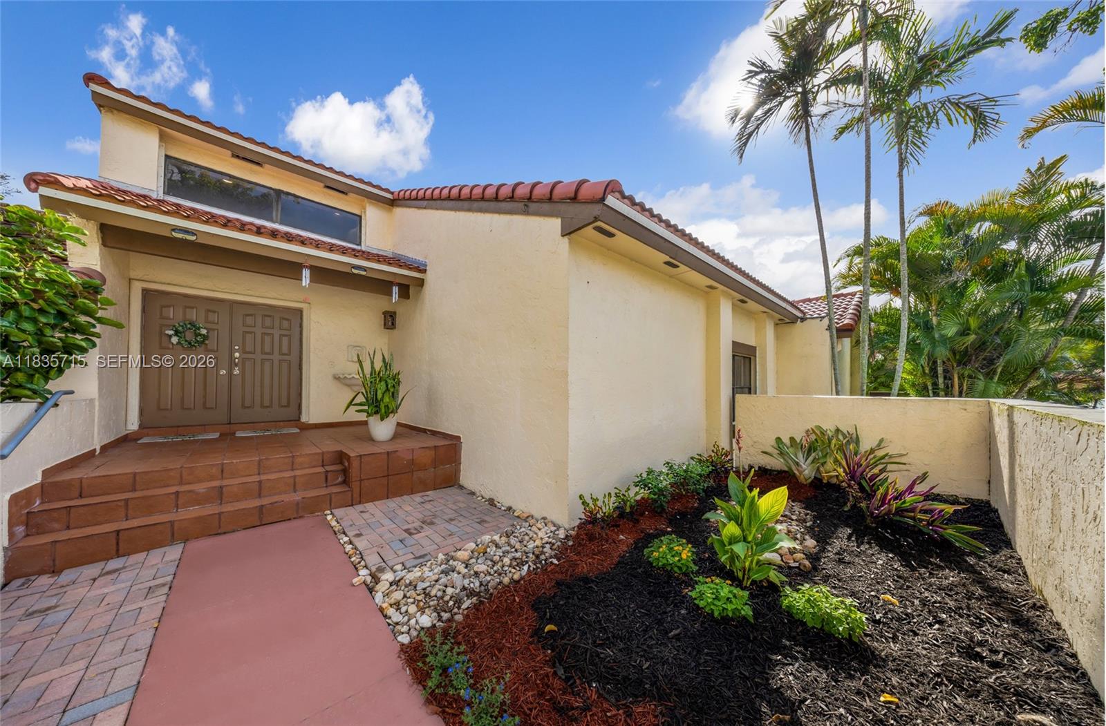 Welcome to this beautifully remodeled, modern townhome in the highly sought-after Moors gated community in Miami Lakes. This 2-bedroom, 2.5-bath residence offers a rare and functional layout, including a sunroom under A/C with sliding glass doors that open to your own private patio—perfect for morning coffee or unwinding at night. Step inside to a dramatic living space featuring soaring 20-foot ceilings and a cozy wood-burning fireplace with classic brick detailing, blending warmth with modern design. The open-concept kitchen is updated with solid wood cabinetry, sleek appliances, and white quartz countertops with a center island, ideal for entertaining. Enjoy the privacy of dual primary suites, with one bedroom on each floor—perfect for guests or flexible living. Major upgrades completed in 2021 include electrical, A/C, water heater, roof, appliances, and washer/dryer. Located within the guard-gated Moors community, residents enjoy resort-style amenities including a pool, lake, fitness center, sauna, clubhouse, tennis courts, basketball court, and park—all with a low HOA and no approval required. Freshly painted with new landscaping and offered vacant for immediate move-in. Just minutes from Main Street Miami Lakes, Miami Lakes Optimist Park, and the Palmetto Expressway, this move-in ready home offers the perfect blend of style, comfort, and location.