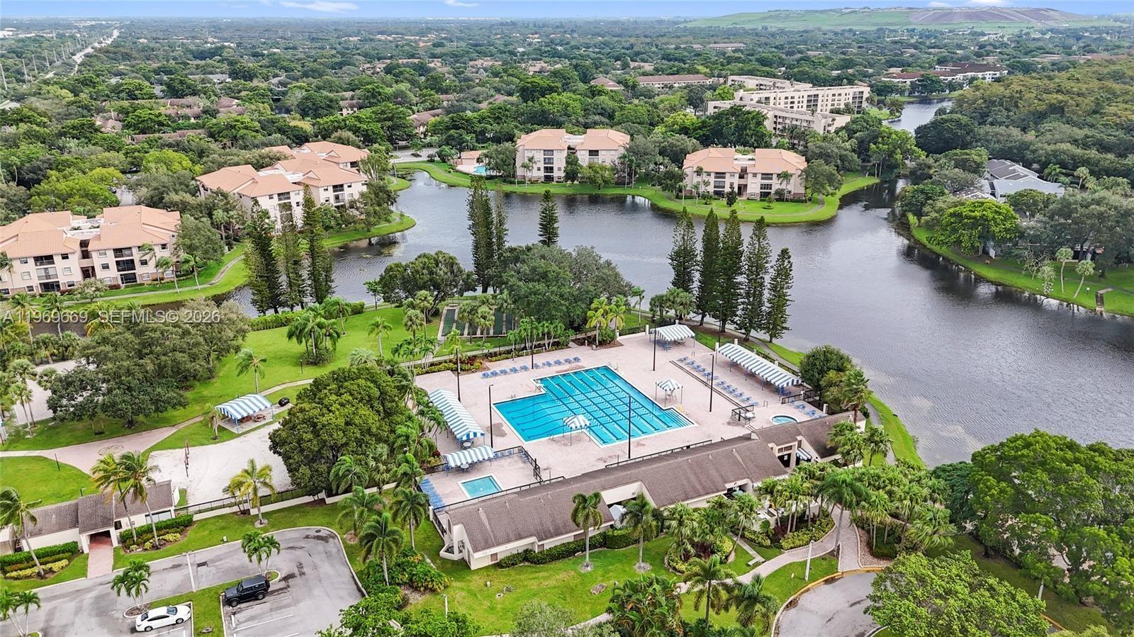 Large, warm and inviting 2/2.5 tastefully upgraded townhome located in the exclusive and desirable Township at Coconut Creek!! A wonderful, tranquil enclave that welcomes ALL ages. Captivating lake views. This very generously sized townhome features a sunny private front patio off the kitchen; a half bath on the first floor; new full sized washer/dryer; large eat-in kitchen with graceful granite counters and modern stainless steel appliances; large dining and living room with expansive glass doors leading to the covered rear patio. Screen enclosed lakeview patio for a cup of coffee to kickstart your morning or to unwind after work with a glass of wine. ***NOTE: the owners run a sought after event decoration business so look beyond the numerous but neat storage bins that occupy the living/dining area***. Upstairs boasts two large en-suites with ample closets including a walk-in and dressing area. You will love living in this move-in ready and easy to maintain townhome so contact the Listing Agent and let's get ready to close!! The Township offers resort style amenities including an Olympic sized pool, clubhouse, fitness room, game room, basketball and tennis courts, volleyball, bike/jogging paths, theater etc. ***Only 1 mile away from The Promenade***. The HOA fee is $425/Month to Golden Raintree VI and only $189/Quarter to the Township Master Association.