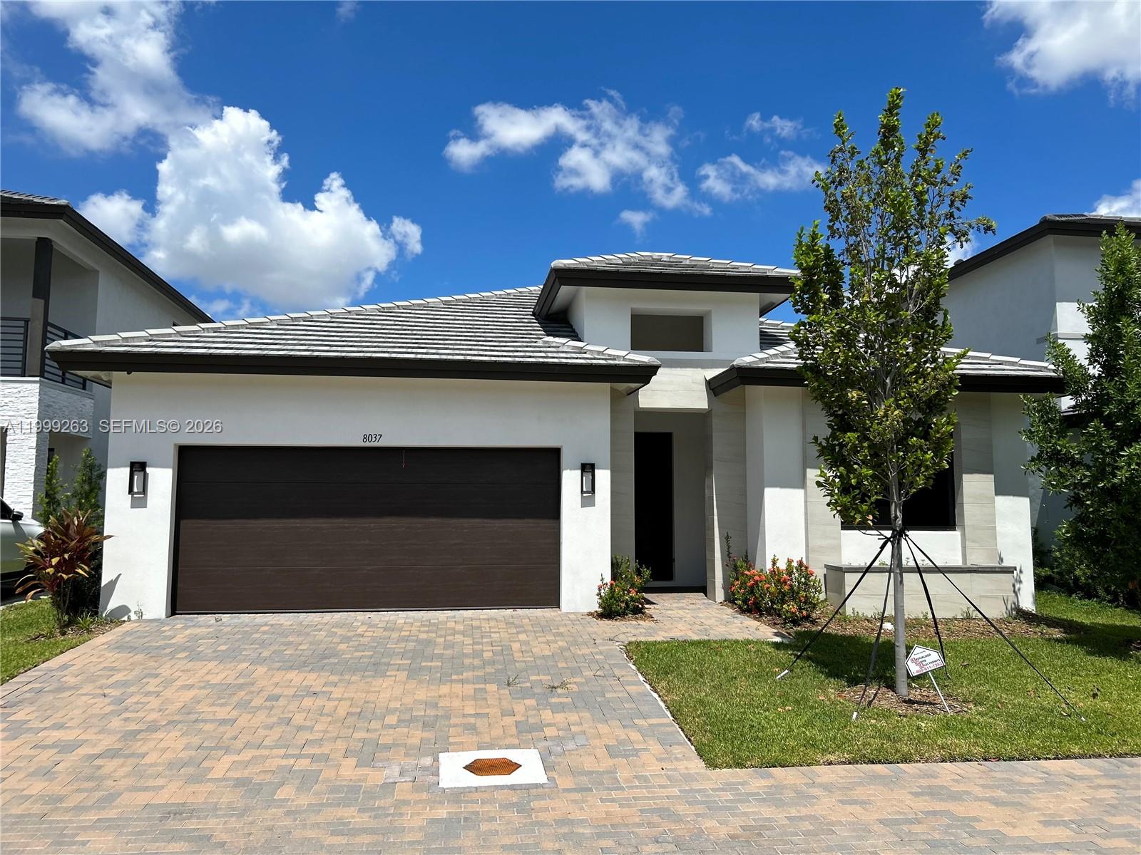 Welcome to this single family residence in the highly desirable Canarias community at Downtown Doral, where modern design meets everyday comfort. This beautifully designed one-story home features 3 bedrooms plus a large den, ideal as a 4th bedroom, home office, or playroom, perfectly suited for today’s flexible lifestyle. Step inside to a bright, open concept layout with high ceilings, recessed lighting, and elegant tile flooring throughout. The sleek, modern kitchen is truly the centerpiece of the home, showcasing quartz countertops, stainless steel appliances, custom cabinetry, and a spacious island perfect for gathering and entertaining. The home is also equipped with a surround sound system throughout, creating an elevated experience whether you're hosting or enjoying a quiet evening in. Step outside to your private backyard with a covered patio and ample green space, ideal for outdoor dining, entertaining, or even designing your future pool. Ideally located within walking distance to Downtown Doral and just minutes from CityPlace Doral, top rated schools, parks, restaurants, and shopping, this home offers both convenience and lifestyle. Situated in a family oriented community, this is a rare opportunity to own a move in ready, modern home in the heart of Doral.