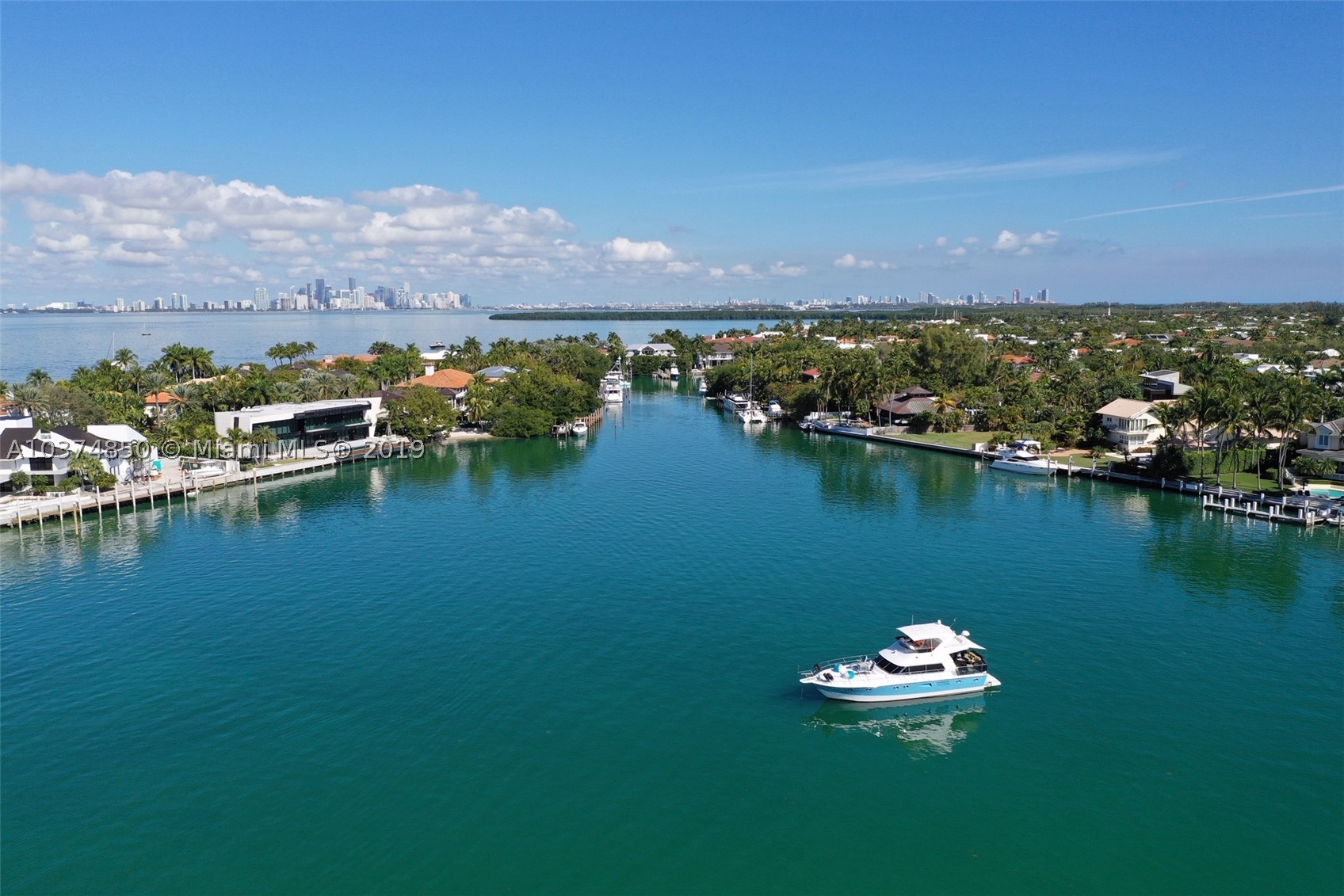 A very special waterfront home (105 waterfront feet) located in protected Hurricane Harbor, with large dock that takes your boat directly into Biscayne Bay with no bridges. Beautiful pool area surrounded by trees for privacy. Short quiet street, Wood floors and open concept with vaulted ceilings. Fireplace. Split bedrooms. 2 car garage.