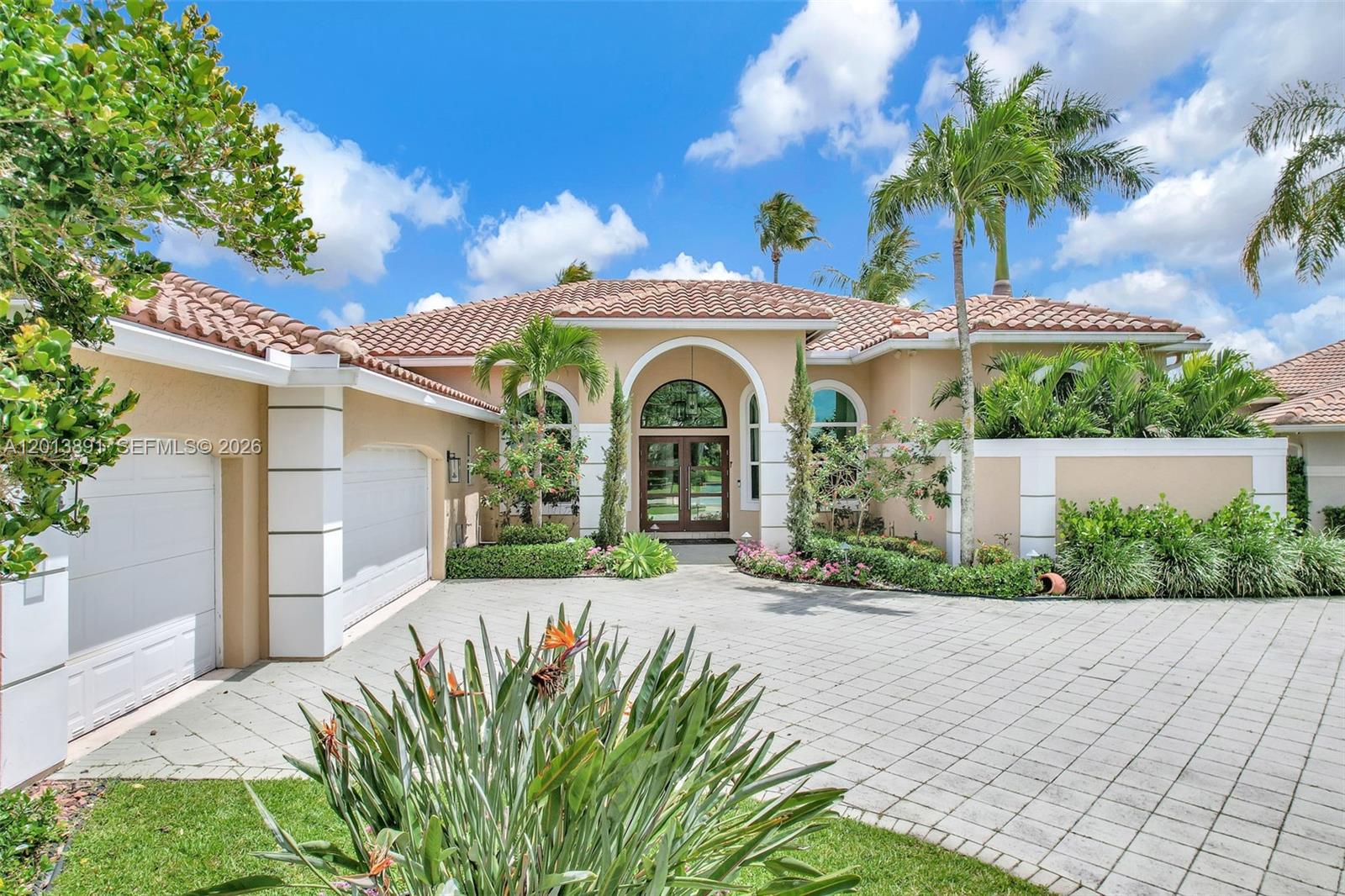 Spectacular fully updated one-story lakefront estate in the exclusive enclave of Edgewater at Weston Hills Country Club. Ideally situated on a peaceful cul-de-sac near the community park, this exceptional residence offers breathtaking panoramic lake views from the moment you enter. Featuring 4 bedrooms plus an office/den and 3.5 baths, the home showcases a spacious split-bedroom layout with volume ceilings and luxury flooring throughout. The redesigned and expanded chef’s kitchen opens seamlessly to an oversized family room, complemented by a high-end multi-room audio system. Outdoor living is elevated with a newly screened resort-style pool, water feature, and expansive patio overlooking tranquil water views. Additional highlights include a newer roof, impact windows and doors, and a 3-car garage with custom cabinetry, epoxy floors, abundant storage, and dual EV charging stations. Located within Weston’s top-rated A+ school district.