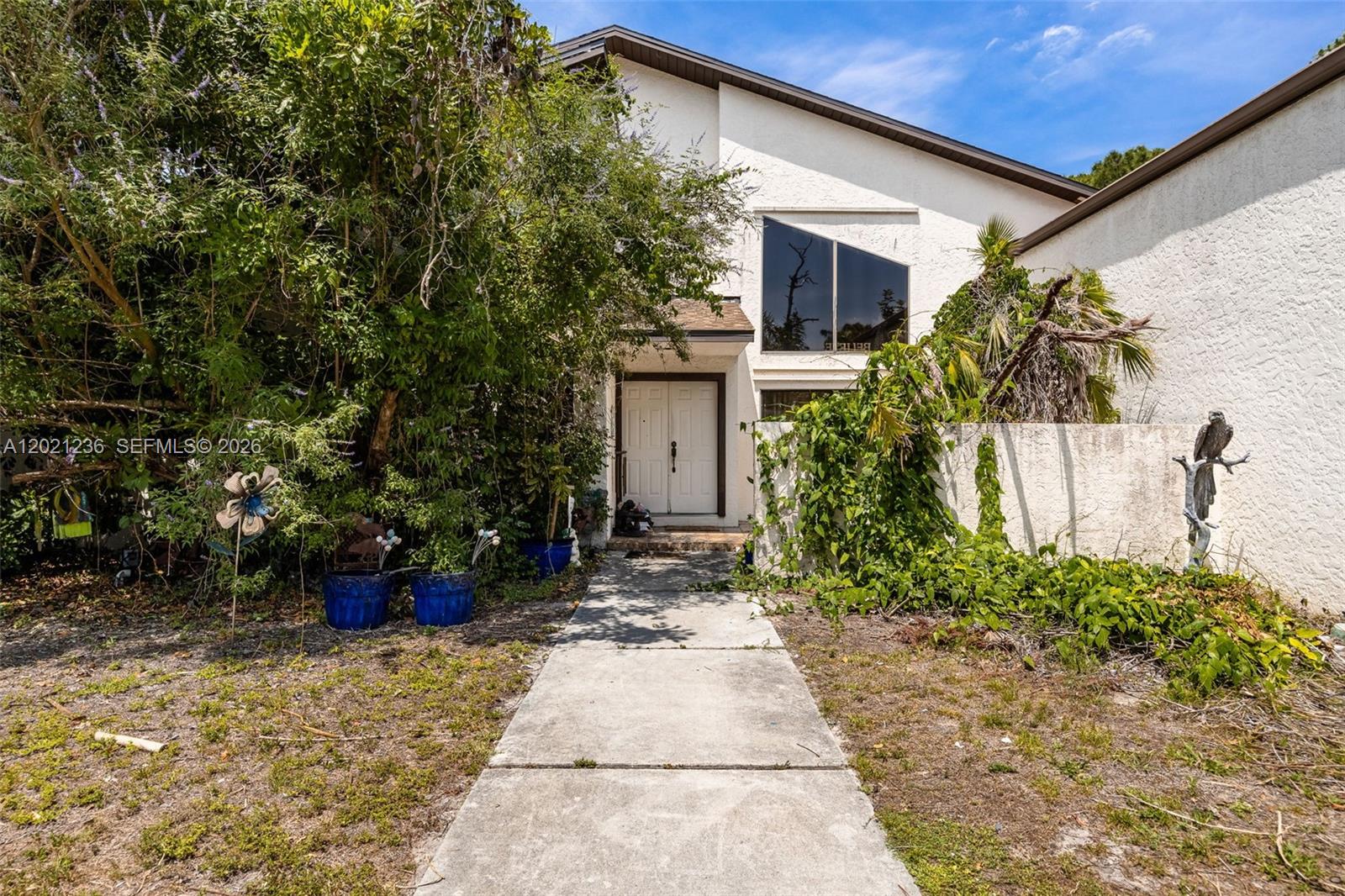 Welcome to an incredible opportunity in Brynwood, one of Fort Myers’ most prestigious and centrally located communities. Just minutes from Bell Tower Shops, dining, shopping, entertainment, medical facilities, beaches, and everything Southwest Florida has to offer, this spacious pool home combines convenience, privacy, and acreage on nearly 3 acres—one of the largest homesites in Brynwood. The property offers endless potential to create the estate-style retreat you’ve always envisioned, with room to expand outdoor living, add a detached garage, entertain, or simply enjoy the extra space and privacy. Inside, the home features 3 bedrooms plus a den that could easily serve as a 4th bedroom, along with a huge upstairs flex space ideal for a game room, media room, office, gym, guest retreat, or playroom. The family room showcases a cozy wood-burning fireplace, while the nearby wet bar area is perfect for entertaining. Outside, the expansive lanai and pool area create the ideal setting for relaxing and enjoying the Florida lifestyle. With a circular driveway, ample parking, and incredible potential for updates and customization, this Brynwood property is a rare opportunity to own space, privacy, and endless possibilities in the heart of Fort Myers.