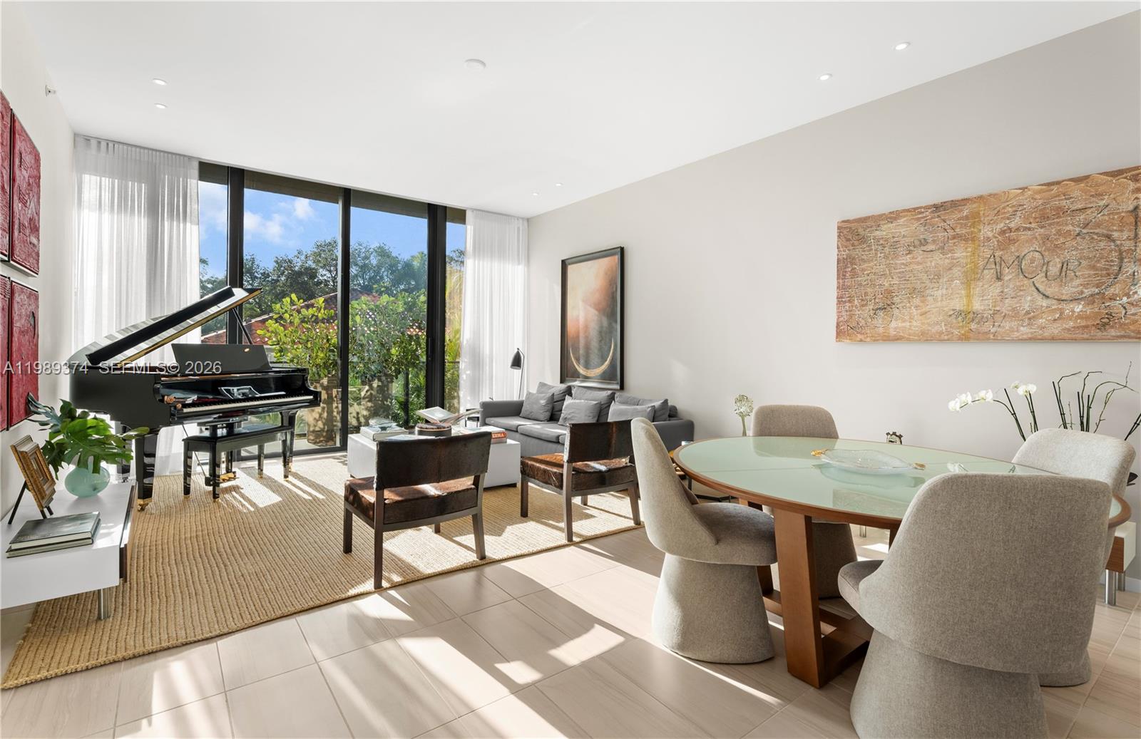 A rare opportunity to own a fully furnished, design-forward residence at GlassHaus Coconut Grove. Defined by natural light and clean architectural lines, this home offers a refined yet inviting atmosphere with thoughtfully curated interiors throughout.
Floor-to-ceiling glass opens to an expansive, sunlit balcony framed by lush greenery, creating a seamless connection between indoor and outdoor living. The living area is refined yet inviting, while the bedroom provides a serene, light-filled retreat.
Offered turnkey, this residence is ideal for those seeking effortless sophistication in a boutique, LEED-certified building rooftop, Gym, and Security—all within walking distance from Coconut Grove’s most desirable destinations.