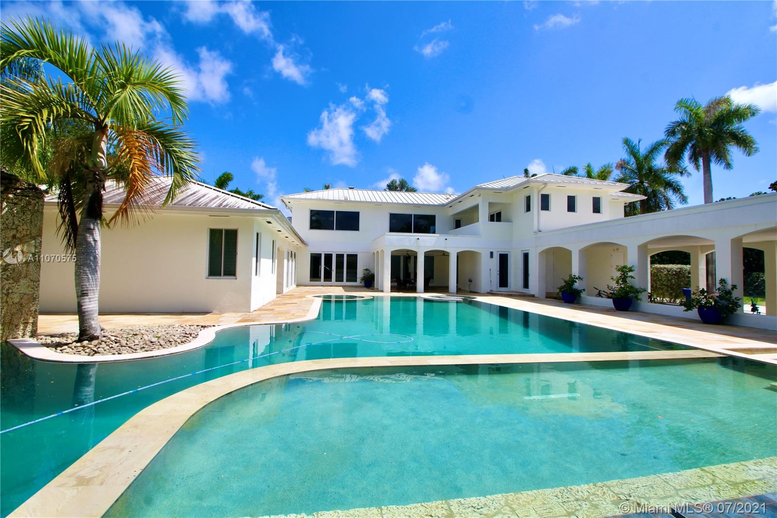 Walled and gated dream home in Pinecrest,  9,165 Sq.Ft. living space on 2.38 acre lot.  House was completely renovated in 2017, including the installation of a gorgeous new pool with waterfall, Jacuzzi and a large, beautiful summer kitchen with built in bbq and pizza oven.  Main property features 6 bedrooms and 7 1/2 bathrooms, in-law quarters, wet bar,  huge family room, laundry room,  2bed/2bath cottage, and full capacity generator.   Carport with space for 4 cars, 2 large storage areas,  2015 aluminum roof, and much more. Amazing opportunity to buy a completely renovated home on 2.38 acre lot in the heart of Pinecrest.