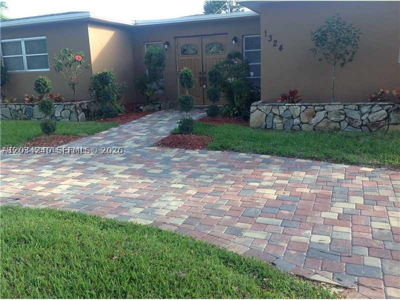Exceptional POOL home on an oversized lot in the Hollywood Lakes area! Featuring 3 beds, 3 baths, a 1-car garage, and approximately 2,400 square feet of living space, this beautifully maintained residence offers the perfect blend of South Florida charm in one of the area’s most desirable neighborhoods.

This home features a spacious, open floor plan filled with natural light and seamless flow between living areas. Generously sized rooms create a warm and inviting atmosphere, ideal for relaxing or hosting family and friends.

This home has been thoughtfully maintained with valuable updates including a 2014 roof, approximately 6.5-year-old A/C system, newer refrigerator and microwave, and a pool heater installed in 2022. Hurricane impact windows and doors provide peace of mind throughout, along with an impact-rated garage door, while the front door is protected with hurricane panels. The exterior was freshly painted last month, and the pool deck has also been recently painted, enhancing the home’s curb appeal and outdoor living spaces.

Step outside to your own private backyard retreat featuring a sparkling pool, screened-in patio, and lush tropical landscaping — creating the perfect setting for entertaining, relaxing, and enjoying year-round South Florida living. A circular paver driveway adds to the home’s impressive curb appeal while providing ample parking.
Just minutes to Downtown Hollywood, FLL Hollywood Airport, and the beaches!