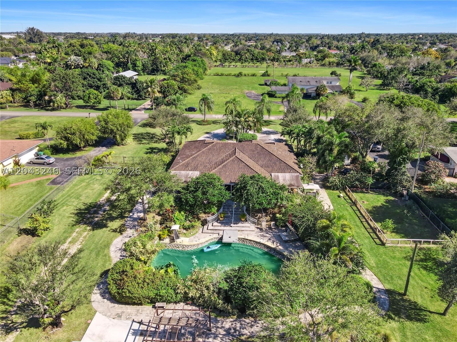 Nestled on the outskirts of Redland, this exceptional ranch-style home sits on 1.16 beautifully landscaped acres and offers a truly unique lifestyle. The residence features 4 bedrooms, 3 bathrooms, and a 2-car garage.

The property is thoughtfully designed with lush tropical landscaping, meandering pathways, assorted fruit trees, storage buildings, a walk-in cooler, animal pens, and a whole-house generator. The outdoor living space is perfect for entertaining, featuring a covered and screened patio with a summer kitchen.

Relax and unwind while enjoying the sights and sounds of the stunning natural swimmable pool and cascading waterfall, creating a private oasis unlike any other.

This one-of-a-kind property combines country living with convenience and is easy to show. Don't miss this rare opportunity!
