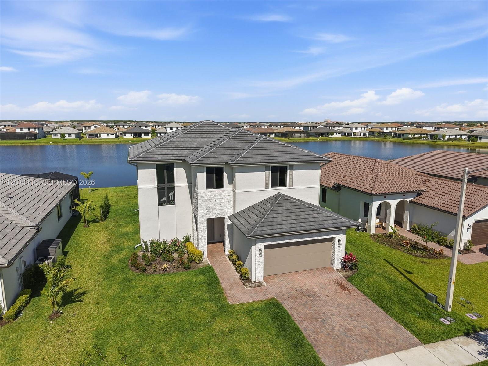 Lakefront home with 3 bedrooms and 2.5 bathrooms in Maple Ridge at Ave Maria. Spacious layout, natural light, and no rear neighbors. Ideal for living or investment.