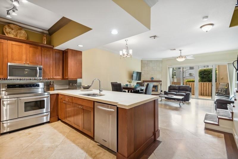 Impeccable two story sought after Victoria Park townhome . This boutique 13 unit two story comes with 2 bedroom 2 1/2 bath with loft den/office that can easily become a 3rd bedroom . Custom kitchen with 9ft granite countertop,with Stainless steel chefs quality appliances,open concept to living/dining with wood burning fireplace great for entertaining.Travintine and wood floors throughout. Oversized primary bedroom,bath and closet. Additional attic storage with bracketed hurricane protection. Hurricane impact windows and garage doors.Relax in your private patio with direct accesses to the community pool. Close proximity Fort Lauderdale beach,Las Olas Blvd ,shopping , Galleria Mall  parks ,  Brightline train station and FTL international airport.