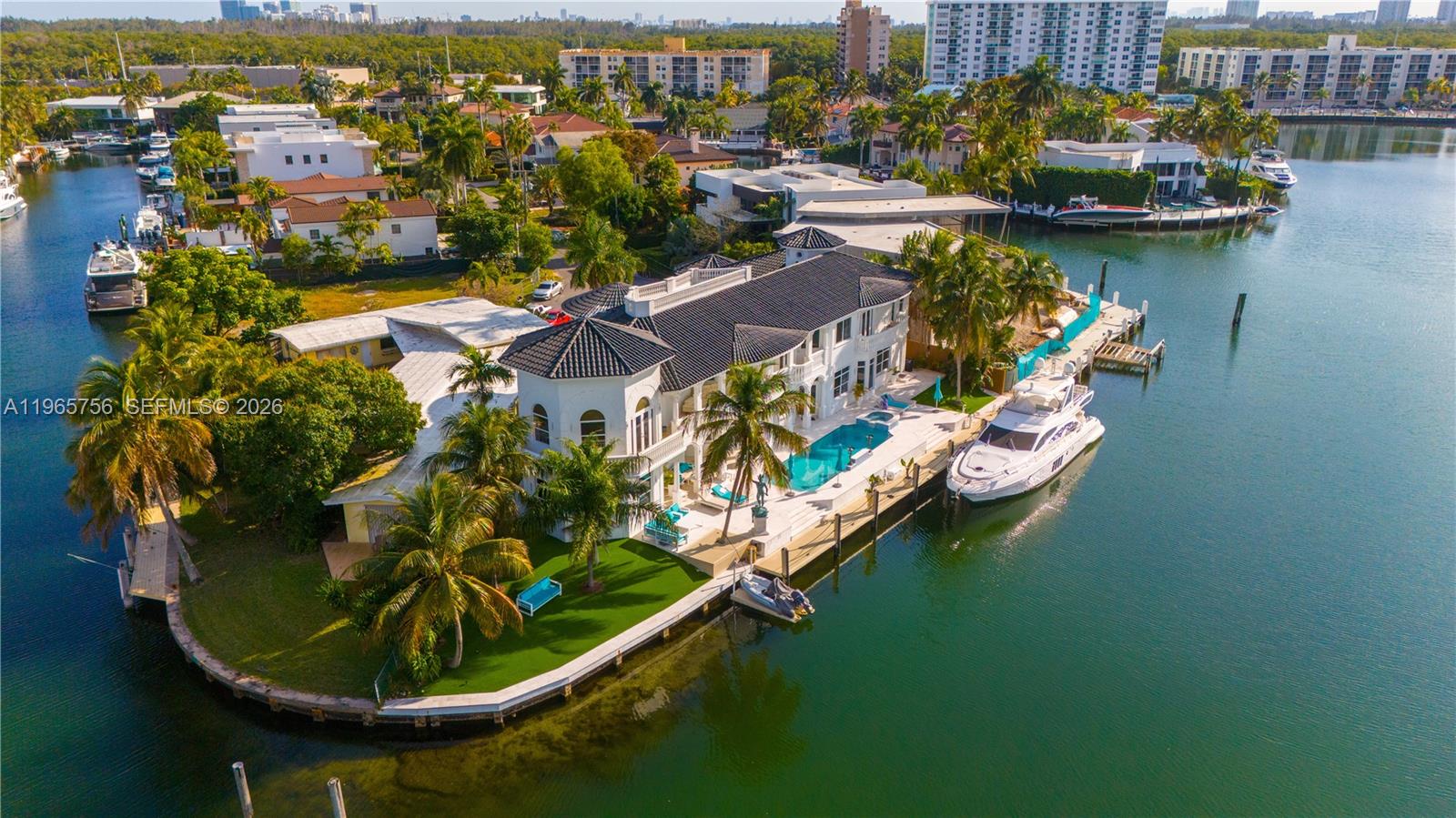 WELCOME TO AN EXTRAORDINARY WATERFRONT ESTATE IN THE PRESTIGIOUS EASTERN SHORES OF NORTH MIAMI—a rare offering that blends modern luxury, security, and resort-style living in one of South Florida’s most exclusive gated communities. This magnificent 5-bedroom, 6-bathroom residence is designed for both grand entertaining and private relaxation. From the moment you enter, you’re greeted by exquisite Italian custom marble flooring, soaring ceilings, and refined architectural details that create a timeless yet contemporary ambiance.
The home features:
A fully equipped private gym for wellness at your convenience, An exclusive in-home club/lounge space—perfect for entertaining guests. A spacious 3-car garage with ample storage, A state-of-the-art 55-camera security system, offering unmatched privacy and peace of mind.
Boasting 200 feet of prime waterfront, this estate provides breathtaking open-water views and direct ocean access—making it a true paradise for yacht owners and those who appreciate South Florida’s waterfront lifestyle. The expansive outdoor areas are ideal for hosting sunset gatherings, with plenty of space to create your dream poolside oasis.
Located in the guard-gated community of Eastern Shores, just minutes from fine dining, luxury shopping, and the beaches of North Miami Beach, this estate offers both exclusivity and convenience.
A rare opportunity to own a secure, private waterfront masterpiece in one of Miami’s most coveted neighborhoods.