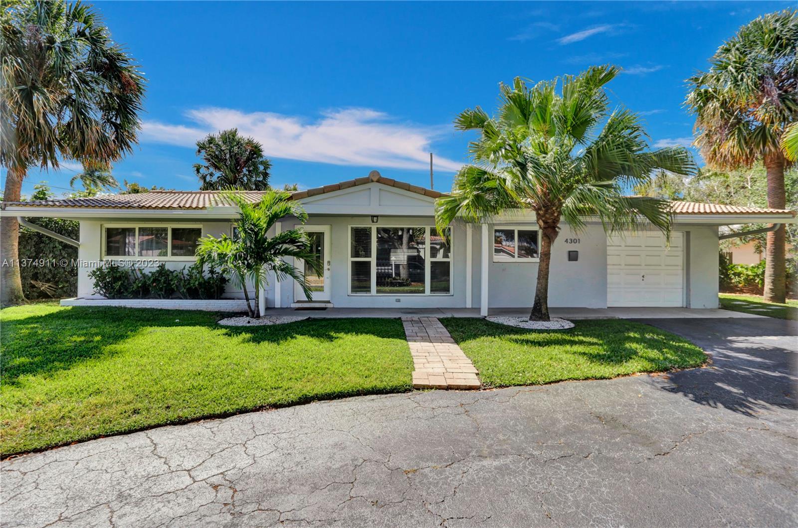 Recently renovated, spacious, turn-key three bedroom and two-bathroom pool home with a one-car garage and circular driveway in highly desired Lighthouse Point. Large open plan living/dining room area with travertine floors throughout. Fully remodeled kitchen, bar counter, white Shaker cabinetry, beautiful marble counters and stainless steel appliances. Split bedroom plan. Large primary bedroom suite includes remodeled ensuite bathroom and cedar walk-in closet. Impact windows, newer electrical boxes and newer outside air conditioning unit. Large, fully landscaped, fenced backyard is great for entertaining. Completely turn-key for AirBnB vacation or long-term rentals. The furniture is available for purchase. Make this wonderful house your easiest move ever.