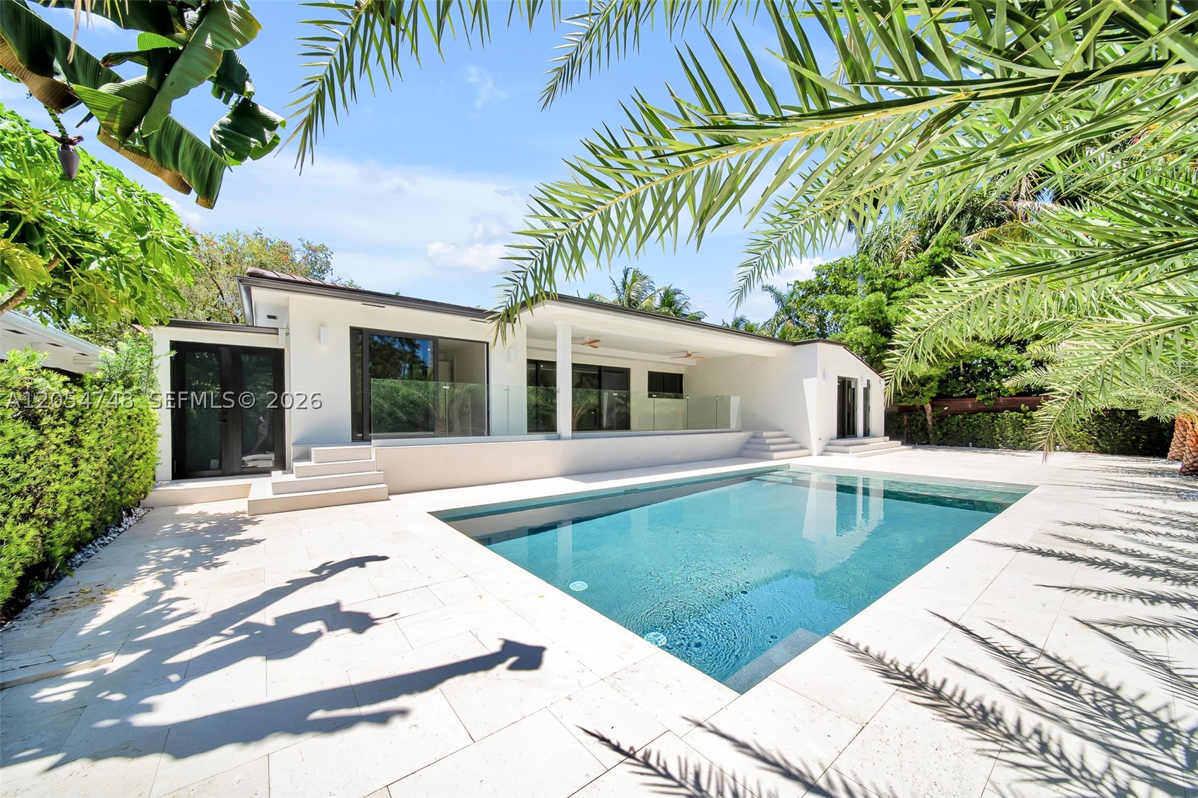 NEVER LIVED IN!Luxurious elevated residence featuring 4 bedrooms, 3 full bathrooms, and 1 half bath, designed with an open-concept floor plan and seamless indoor-outdoor living, perfect for entertaining. Tucked away on a quiet dead-end street in Miami's sought-after Bayside Historic District, this exceptional home offers privacy, elegance, and convenience. Soaring ceilings welcome you into a chef's kitchen with premium appliances, a gas cooktop, stunning Brazilian stone countertops, breakfast area, and dedicated laundry room. Every bathroom is finished with natural stone, while the spacious primary suite features a custom illuminated walk-in closet. Enjoy a resort-style pool, lush tropical landscaping, mature palm trees for added privacy, and a separate concrete-block storage room. One bedroom offers a glimpse of the bay and the beautiful waterfront park across the street. Ideally located within walking distance to restaurants, cafés, shops, and parks, and just minutes from Miami's most vibrant neighborhoods. No garage, but ample parking for up to four vehicles. Located in one of Miami's fastest-growing areas, surrounded by newly built multi-million-dollar homes, this property offers an outstanding opportunity for luxury living and long-term value.