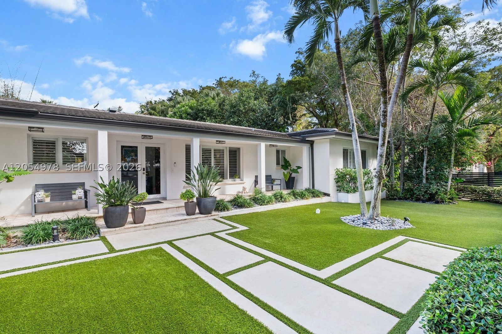 Modern and gated home with a large 12,437 sq. ft. Lot on prestigious Riviera Drive. 4 Bedroom/ 3.5 Baths/ 2 car Garage, with Heated Pool. The open floorplan and glass walls fill the home with light and views of the beautiful back yard pool area from every room. The home features a large Primary Bedroom with Sitting Area, large Master Bathroom with dual sinks and Steam Bath, Spa/Tub, and 2 walk-in closets. Split bedroom floorplan. New Roof, updated Kitchen and large 3' x 3' porcelain tiles in main living area. Covered Terrace area and Pool area offers the best of Florida Living. Corner lot with lots of parking. Walk under tropical canopies along the neighborhood's side walked streets. 2 mile walk to downtown Coconut Grove. The Best of South Coral Gables!