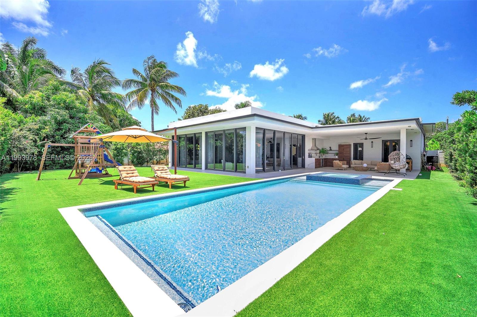 Stunning residence built in 2023 in the desirable North Miami area, located in Biscayne Gardens. Beautifully designed and styled, this modern home showcases high-end finishes with premium materials, including marble and wood accents throughout. The thoughtfully curated layout flows seamlessly to a private backyard oasis with a resort-style pool—ideal for refined family living and effortless entertaining. Airbnb-friendly with proven income potential, this turnkey property may be offered furnished, presenting an exceptional opportunity for both end-users and investors in a centrally located Miami neighborhood.