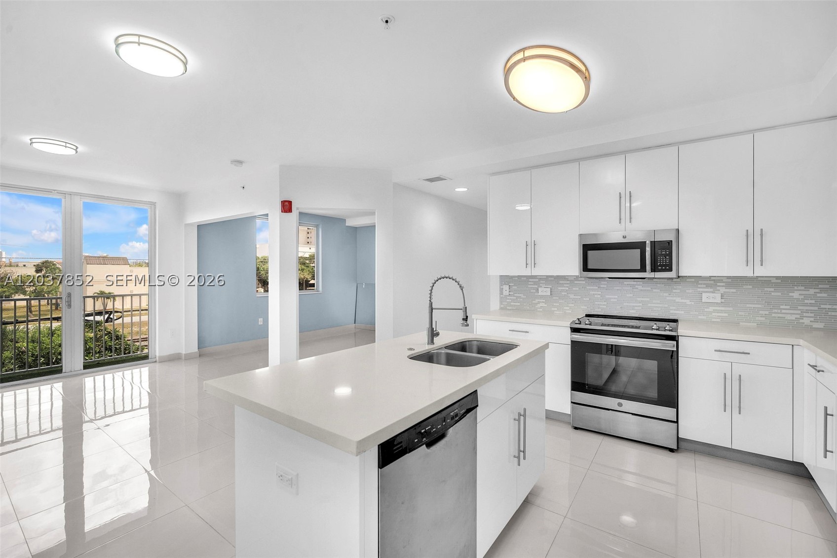 Beautiful corner unit!! secured building w/elevator. Great location. Luxury Italian kitchen w/wood cabinetry, island, quartz counters & S.S. appliances open to dining & living area. 2 BEDS, 2 BATHS + DEN with window that can be office/playroom/3rd bedroom. Porcelain white tile throughout. Open floor plan w/balcony. Natural lighting. High impact windows & doors. Aventura Waterways K-8 Center public "A" rated school. W/D in unit. 2 assigned parking. Water,cable,alarm included. Community pool.