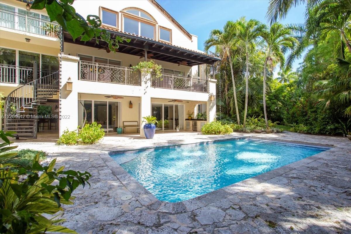 Three levels of understated elegance set in a tropical garden. Perfect for entertaining inside and out, this spectacular light-filled 4 bedroom 4 1/2 bath home is located in the heart of prestigious and secluded Entrada Estates: 24/7 guarded/gated enclave, community tennis courts, shared water rights/access to a boat dock. Located south of Coconut Grove with excellent schools, walking distance to Grove restaurants, cafes. Third level features a spacious master and elegant bath, En-suite bedroom, and bedroom with adjacent bath, and an ample mezzanine-style library with sitting area and office space. Ground level: 2 car garage ,1 BR/1BTH, large living space opening up to the pool patio, which includes a complete outdoor kitchen, all surrounded by lush tropical landscaping.