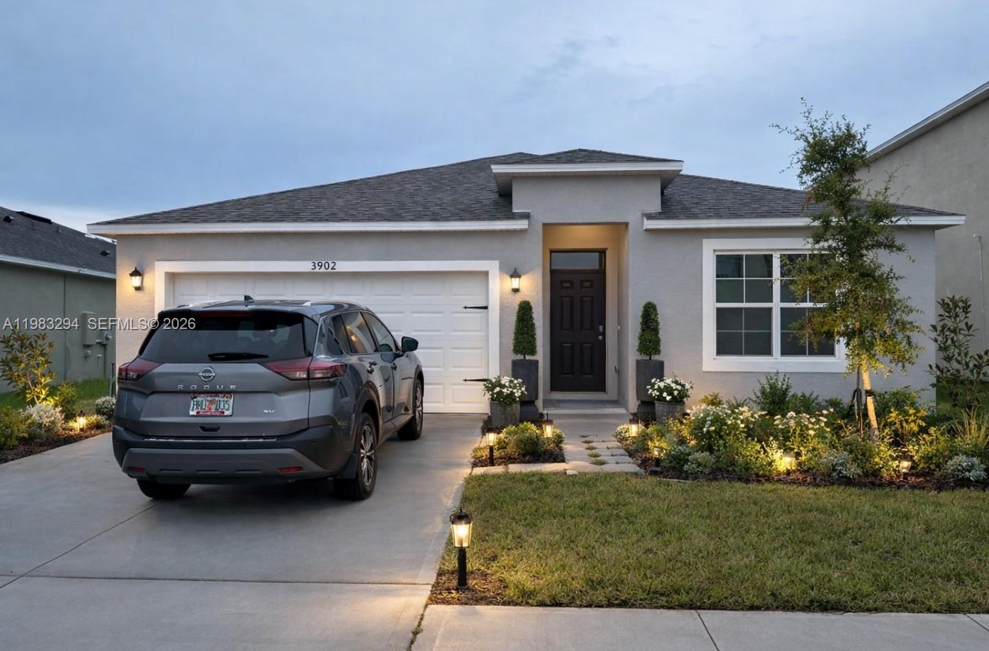 Spacious 4-bedroom, 2-bath single-family home located in a quiet, family-friendly community in Bartow, just 10 minutes from Lakeland. Property features a large fenced backyard with extended concrete patio, perfect for outdoor entertaining, and a 2-car garage. The primary suite offers two closets for ample storage. Home is equipped with a Samsung smart refrigerator with digital screen and Alexa integration, Samsung washer and dryer (like new), glass-top range, and dishwasher. Security system installed with door alarms and exterior cameras. Community amenities include a pool, dog park, and playground.