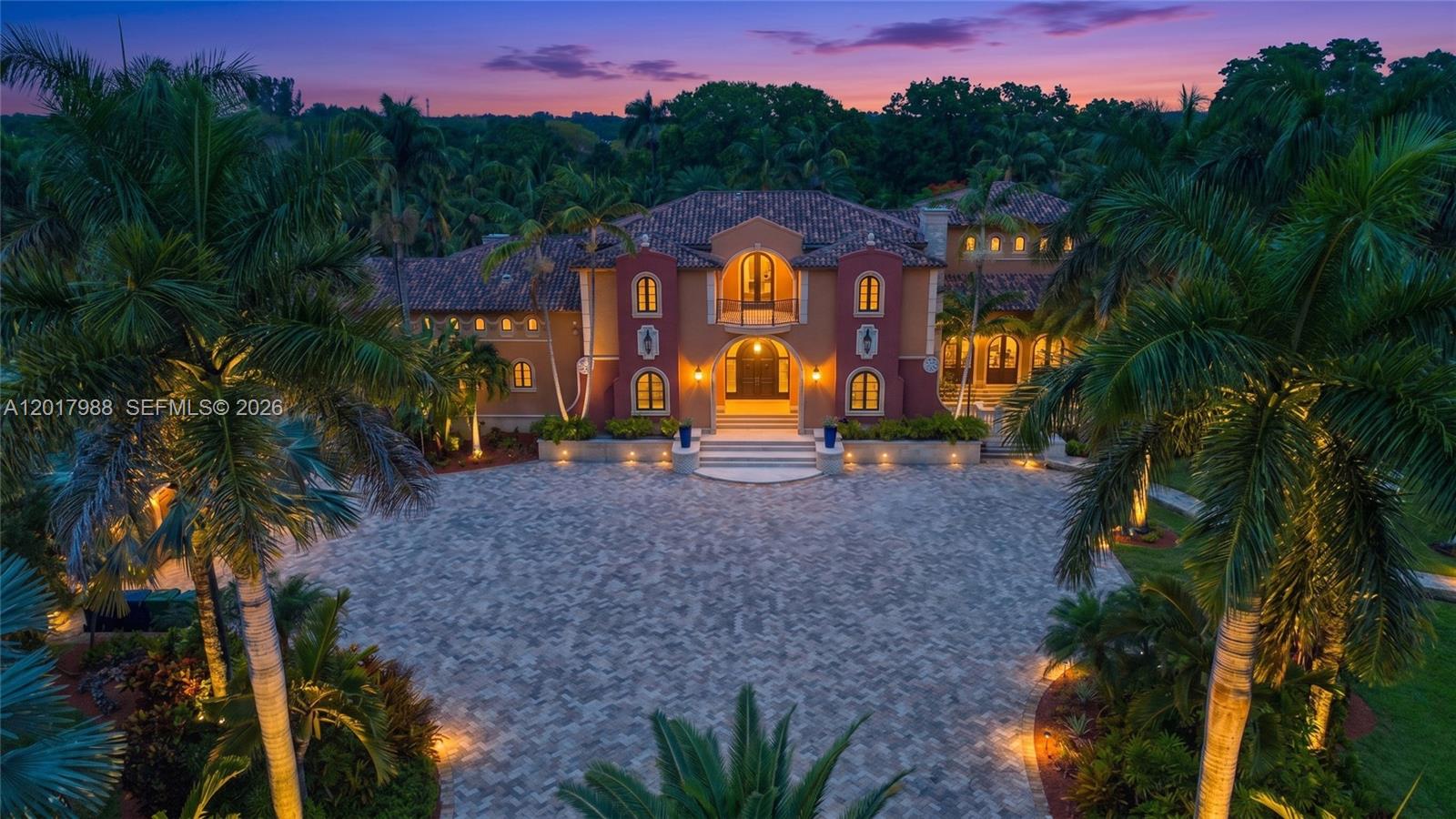 Extraordinary 10-acre estate sitting on The Redlands Country Club in Miami’s Redland community offering approximately 16,000 SF of luxury, privacy, and resort-style living. Designed and built to stand for generations, this gated compound is surrounded by lush tropical landscaping with distant views of the Redland Country Club golf course. The grounds are truly spectacular, featuring a swimmable crystal-clear lagoon with dramatic 8-10 ft waterfalls, a white sand beach, and a producing 5-acre coconut grove that may qualify for agricultural exemption benefits. Inside, exceptional craftsmanship and globally sourced materials define the residence, including walnut plank flooring, San Pedro mahogany, Jerusalem travertine, Bolivian stone, custom murals, marble, quartz, and designer finishes throughout. A Crestron and LiteTouch smart home system controls lighting, climate, security, cameras, music, landscape lighting, and gates. Designed for entertaining on every scale, the estate includes a chef’s kitchen with butler’s pantry, summer kitchen, wine tasting room, Moroccan lounge, meditation room, gym, guest quarters, trophy room, rod-and-reel safe room, workshop, expansive terraces, balconies, verandas, and a 5-car garage. Advanced UV, charcoal, and reverse osmosis water filtration system included. A rare legacy property unlike anything else in South Florida.
