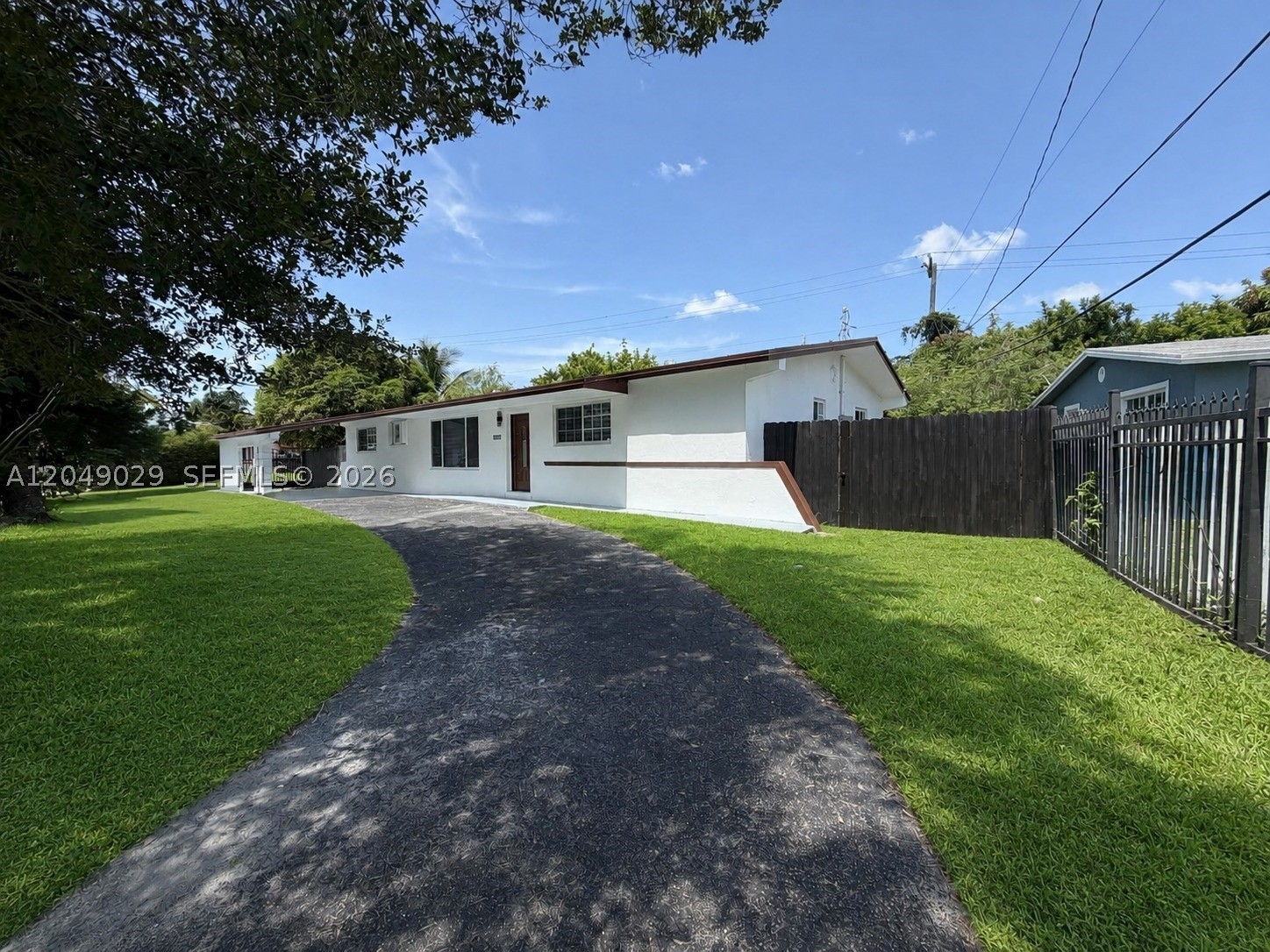 Welcome to this beautifully renovated corner home in Miami Gardens, where every detail has been thoughtfully updated for modern, comfortable living. Step inside to discover brand new porcelain white floors throughout, creating a bright and airy feel from the moment you walk in. The open-concept kitchen features wood cabinets, granite countertops, and stainless steel appliances, perfect for everyday cooking and entertaining. Modern finishes, fresh paint throughout, and updated bathrooms make this a true turnkey property. Safety and peace of mind are covered with  some impact windows and doors plus hurricane shutters. Outside, this gated corner home sits on a spacious lot that truly sets it apart, offering parking for 8+ cars, space for a boat, mature fruit trees, and a large shed for extra storage. The big covered porch is perfect for entertaining, family gatherings, or simply enjoying the South Florida lifestyle. Washer and dryer are included. Quiet street. Plenty of natural light throughout. Conveniently located near top-rated schools, shopping, restaurants, parks, and major highways, everything Miami Gardens offers is right at your doorstep. Whether you're looking for a place to call home or a hassle-free rental with everything new and ready,  this is a rare opportunity you don't want to miss. Just bring your belongings and make yourself at home. This one won't last.