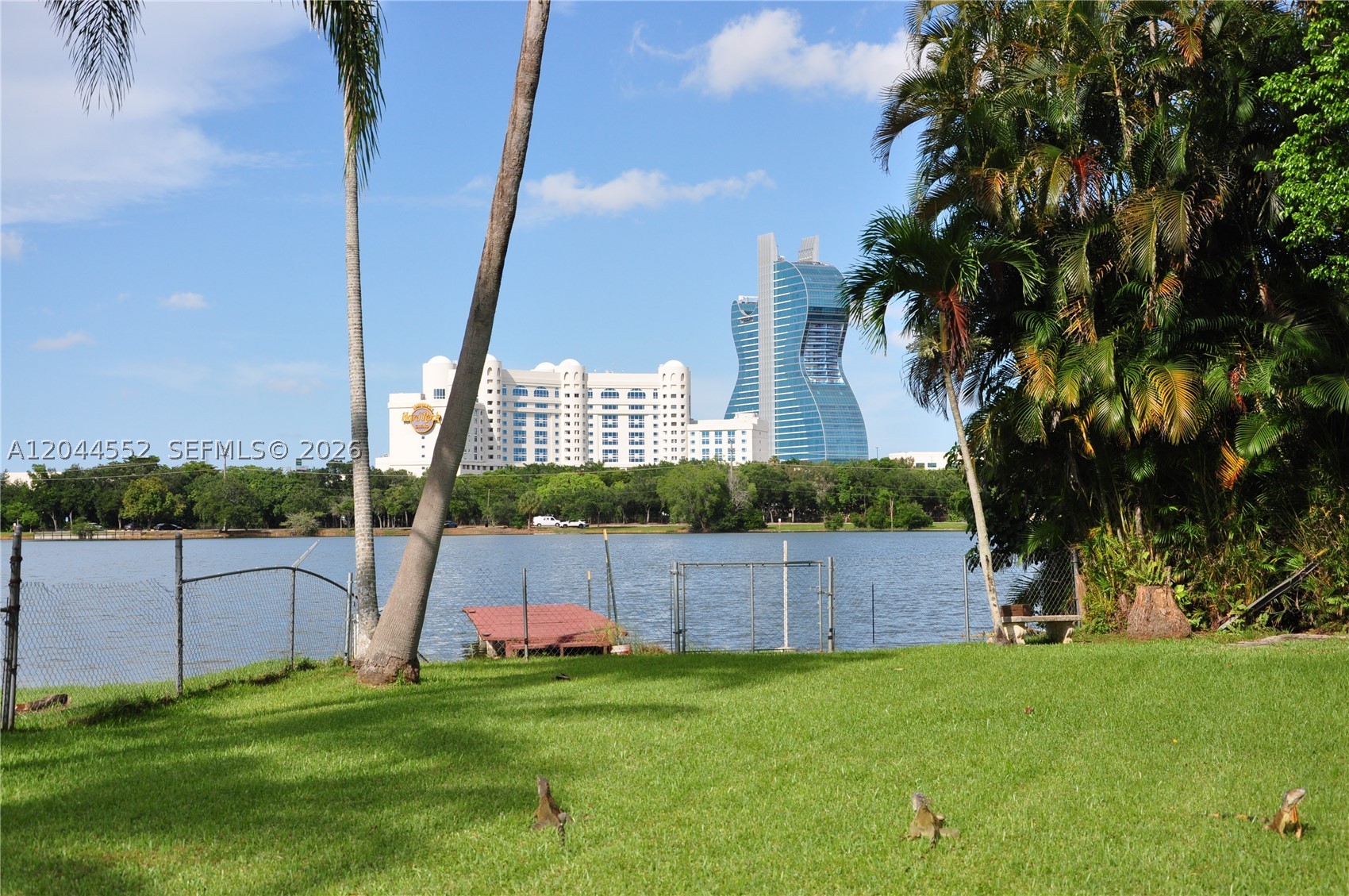 Nestled on a spacious corner lot, this charming 4 bedroom/2 bathroom home offers one of its most impressive features, a huge, private backyard overlooking a beautiful lake, creating the perfect setting for entertaining, relaxing, or enjoying South Florida sunsets. Ideally located walking distance from the iconic Seminole Hard Rock Hotel & Casino, shopping, dining, major highways, and entertainment. With no HOA, you'll enjoy the freedom to make this property your own. The home features a convenient carport and offers endless potential for buyers looking to update and personalize a well-located property. Don't miss this rare opportunity to own lakefront property with an unbeatable location and incredible outdoor space. A/C is 3 years old and hot water tank is 2 years old.