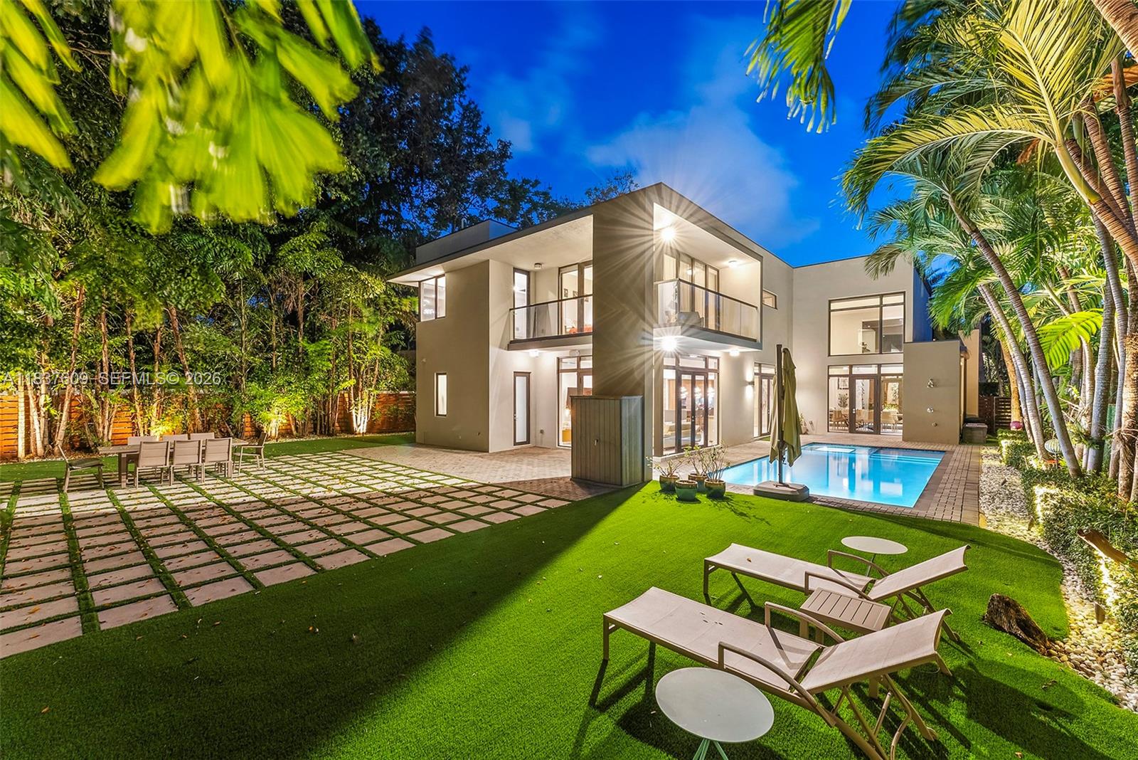 Discover the pinnacle of luxury in this extraordinary smart home nestled in one of South Miami’s most coveted enclaves. Designed with comfort, privacy and effortless sophistication in mind, the residence features a full  automation system controlling lighting, climate, motorized shades, and premium surround sound throughout the main living areas. The open concept layout includes a gas fireplace, built-in bar, library nook and an elegant Brazilian wood-accented wall. The gourmet kitchen is appointed with Italian Mia Cucina cabinetry, Wolf and SubZero appliances, gas range, and a spacious walk-in pantry. Upstairs a former guest bedroom has been transformed into a striking home theatre with a 110” screen, while its former bathroom has been reimagined as a retro-inspired kitchenette. The adjacent guest bedroom has been converted into a playful game room enhancing the home's entertainment appeal. The luxurious primary suite offers a private balcony, spa-style bath with oversized dual shower, and a generous custom closet. Step outside to a year round entertaining retreat featuring a sparking pool, artificial turf lawn, and outdoor shower. Additional highlights include a two car air conditioned garage, EV charger, and abundant storage. This home is truly turnkey and designed for elevated modern living.