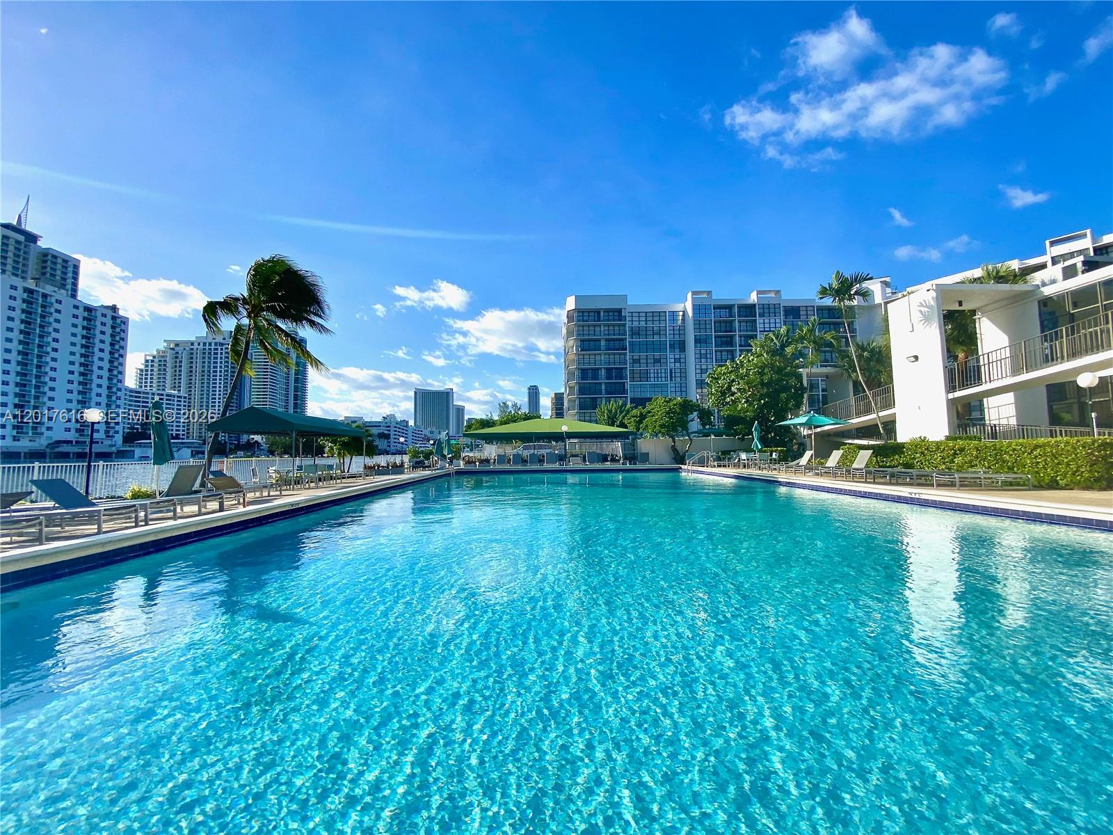 Experience BREATHTAKING PANORAMIC VIEWS from this TOP-FLOOR CONDO, where you can enjoy spectacular sunsets overlooking THREE ISLANDS, HALLANDALE BEACH, and beyond from your private balcony. This updated 2-BED/2-BATH residence features TILE FLOORING, FLOOR-TO-CEILING WINDOWS, and abundant closet space, with HOTWIRE FISION TV + HIGH-SPEED INTERNET INCLUDED. Located in a waterfront, walkable, GATED COMMUNITY, you’re moments from parks, playgrounds, WORLD-CLASS BEACHES, dining, entertainment, shopping, and golf. Resort-style amenities include an INTRACOASTAL POOL, sun deck, BBQ area, fitness center, tennis courts, and clubhouse, plus 24-HOUR SECURITY, front desk service, ASSIGNED PARKING, guest/street parking, a storage unit, and same-floor laundry. INVESTOR FRIENDLY – RENT IMMEDIATELY! Situated in the exclusive and highly sought-after THREE ISLANDS AREA, just minutes to the beach. Contact us today to schedule a private tour!