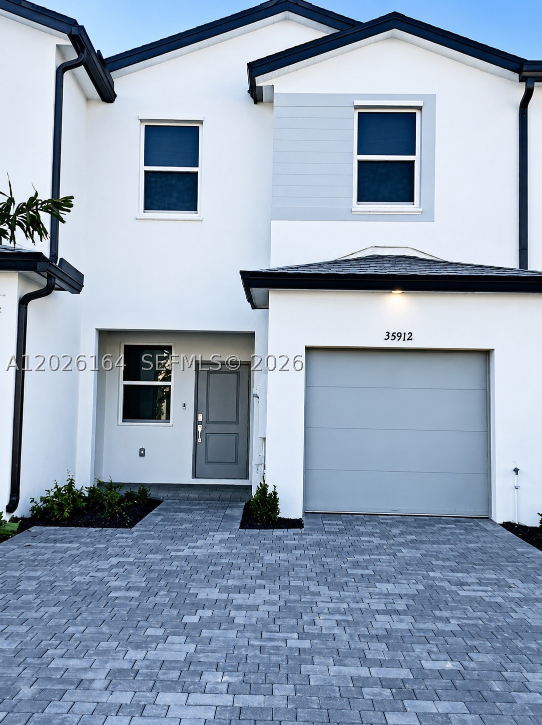 Brand-new 3-bedroom, 3-bathroom townhome located in a desirable Homestead community. LOT  & BLOCK. This modern property features a functional open layout with one bedroom and a full bathroom conveniently located on the first floor, ideal for guests, in-laws, or a home office. Upstairs, two spacious en-suite bedrooms each offer private bathrooms for added comfort and privacy. The bright living and dining areas flow seamlessly into a contemporary kitchen equipped with stainless steel appliances, sleek cabinetry, and a center island perfect for entertaining and everyday living. Sliding glass doors lead to a private fenced patio, creating a great outdoor space to relax or host gatherings. Community amenities include a clubhouse, swimming pool, and playground. Conveniently located near major highways, shopping centers, restaurants, schools, and outdoor recreational areas. Move-in ready and perfect for first-time buyers, families, or investors seeking a modern home in a growing area.