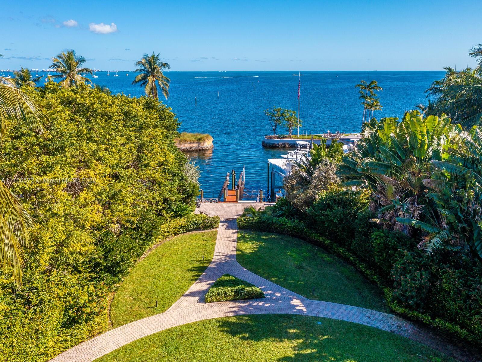 Reminiscent of an Italian palazzo, this home with DEEDED DOCK is located in Hughes Cove, the most exclusive waterfront gated community in Coconut Grove. A huge portico with stunning gates and 24-hour security welcome you to 11 upscale homes, a private tennis court & park. Ascend the grand stairway to the property courtyard entrance that leads you to a magnificent home w/ 11,117 sq/ft of luxury living w/ the finest of finishes. The special features include a spectacular rooftop terrace overlooking Biscayne Bay, elevator, office, heated saltwater pool, expansive main bedroom w/ seating area, solarium, gas generator & private marina with deeded dock. This grand property is located next to Ransom Everglades and Carrolton Schools.